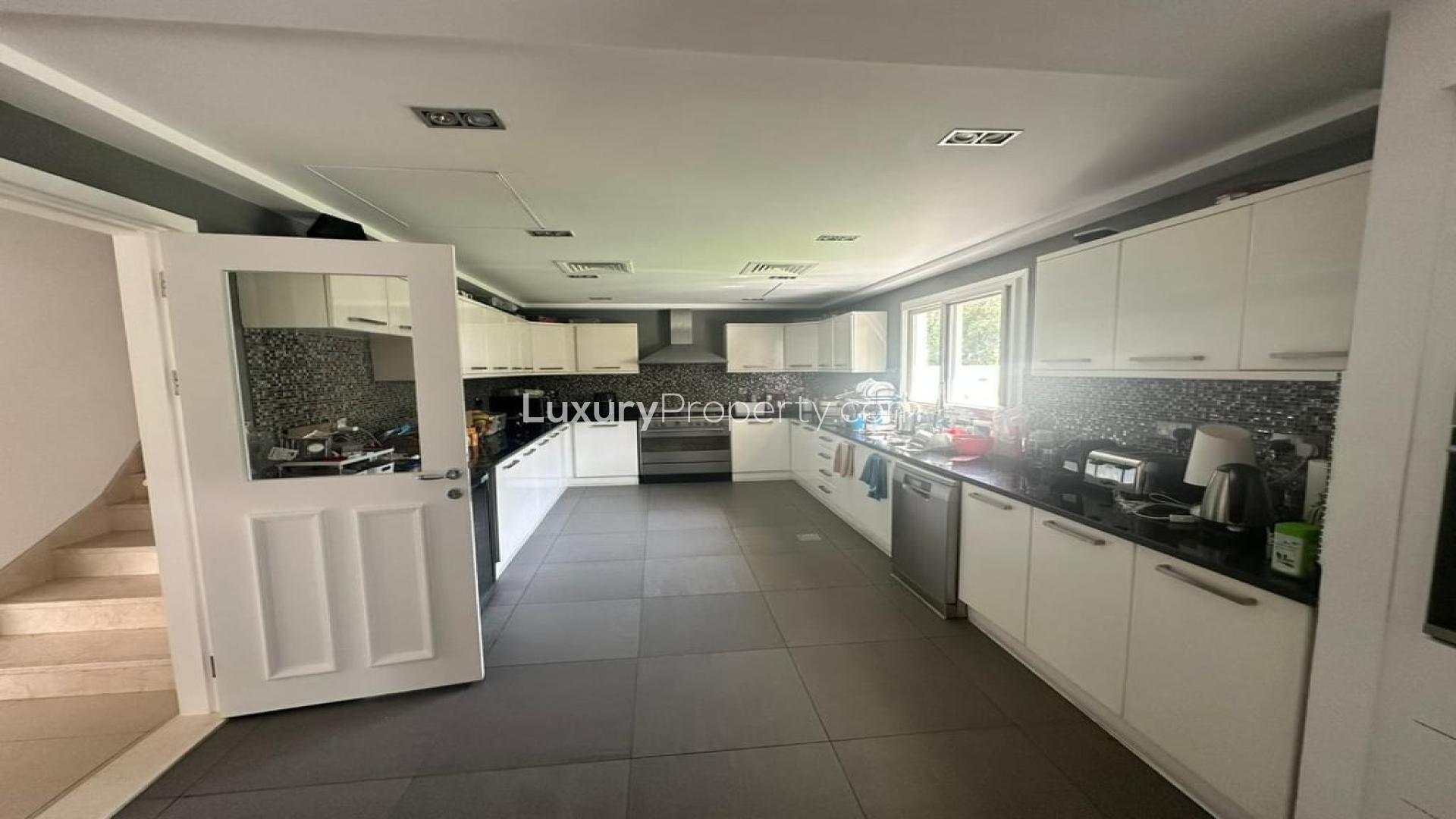 Elegant living room in 4-bedroom Meadows villa with garden and pool view