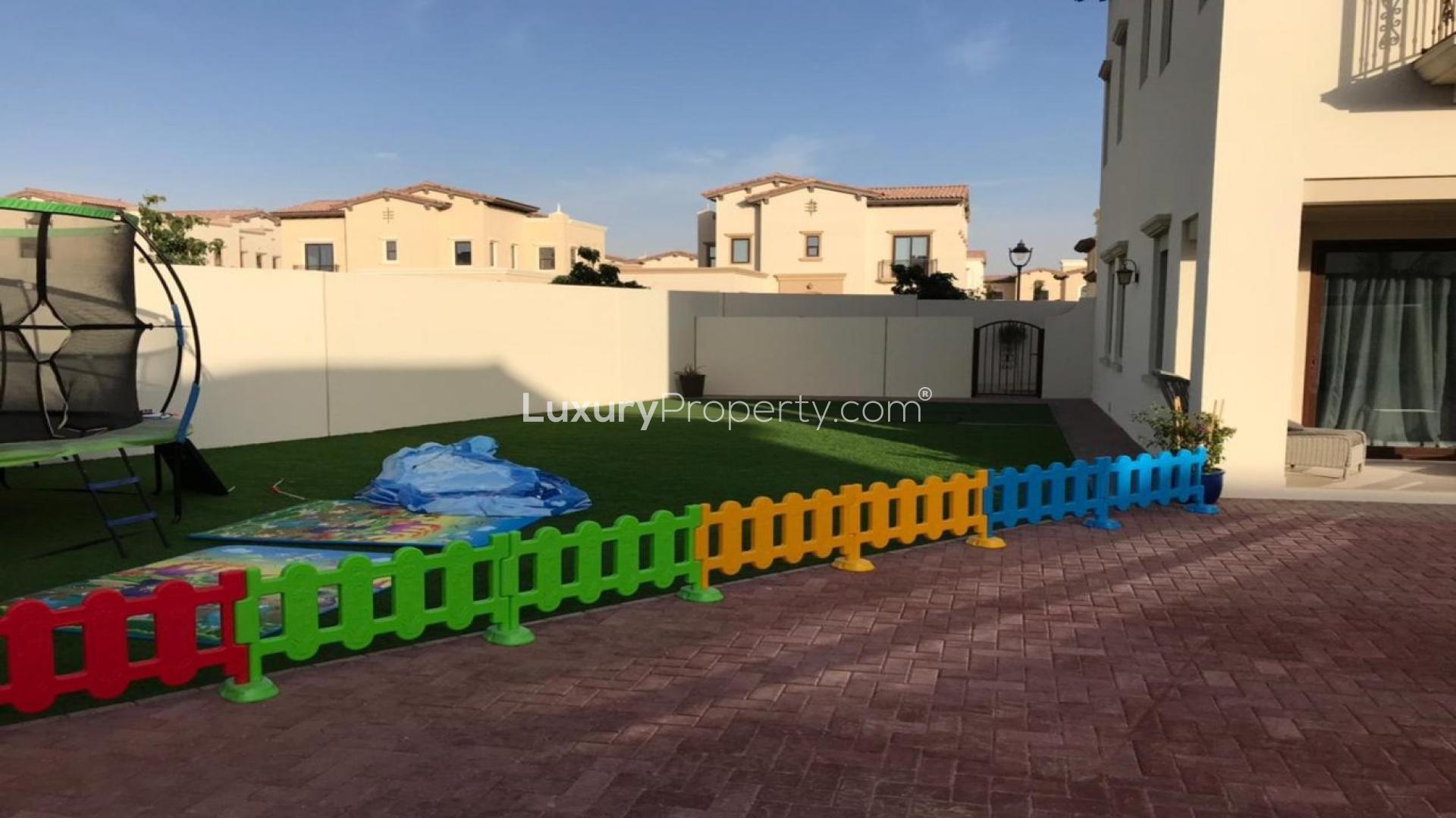 Dining area in Arabian Ranches 2 villa with zebra-print chairs and large windows