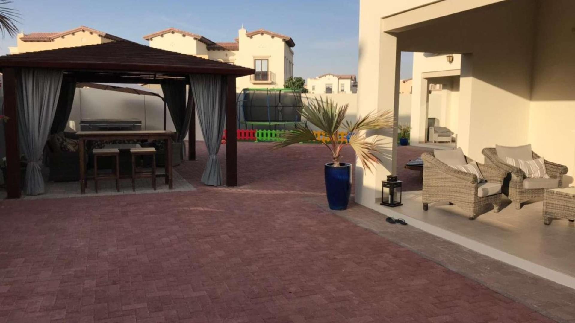 Spacious garden of villa in Arabian Ranches 2, Rosa community, featuring potted plants