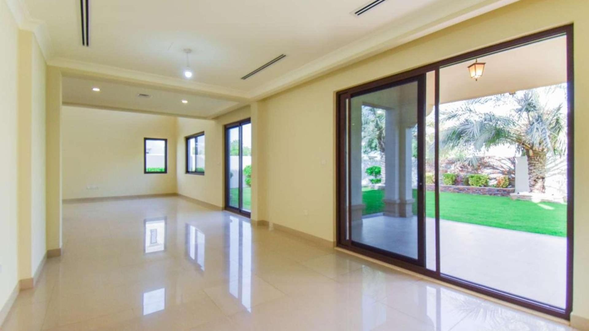 "Spacious balcony view of Yasmin villas in Arabian Ranches 2, available for rent.",Spacious living area with garden view in Yasmin villa, Arabian Ranches 2 for rent