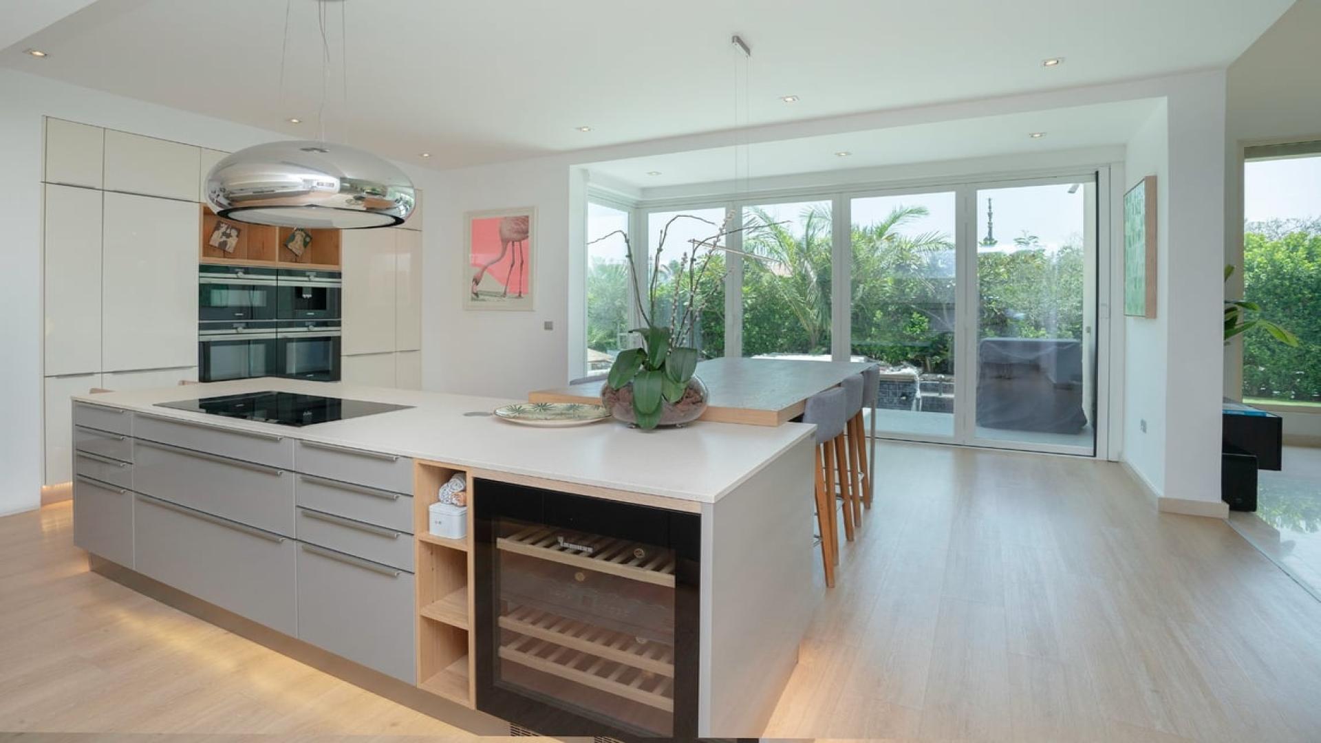 Spacious living room in furnished Jumeirah Islands villa, European Clusters, with garden view