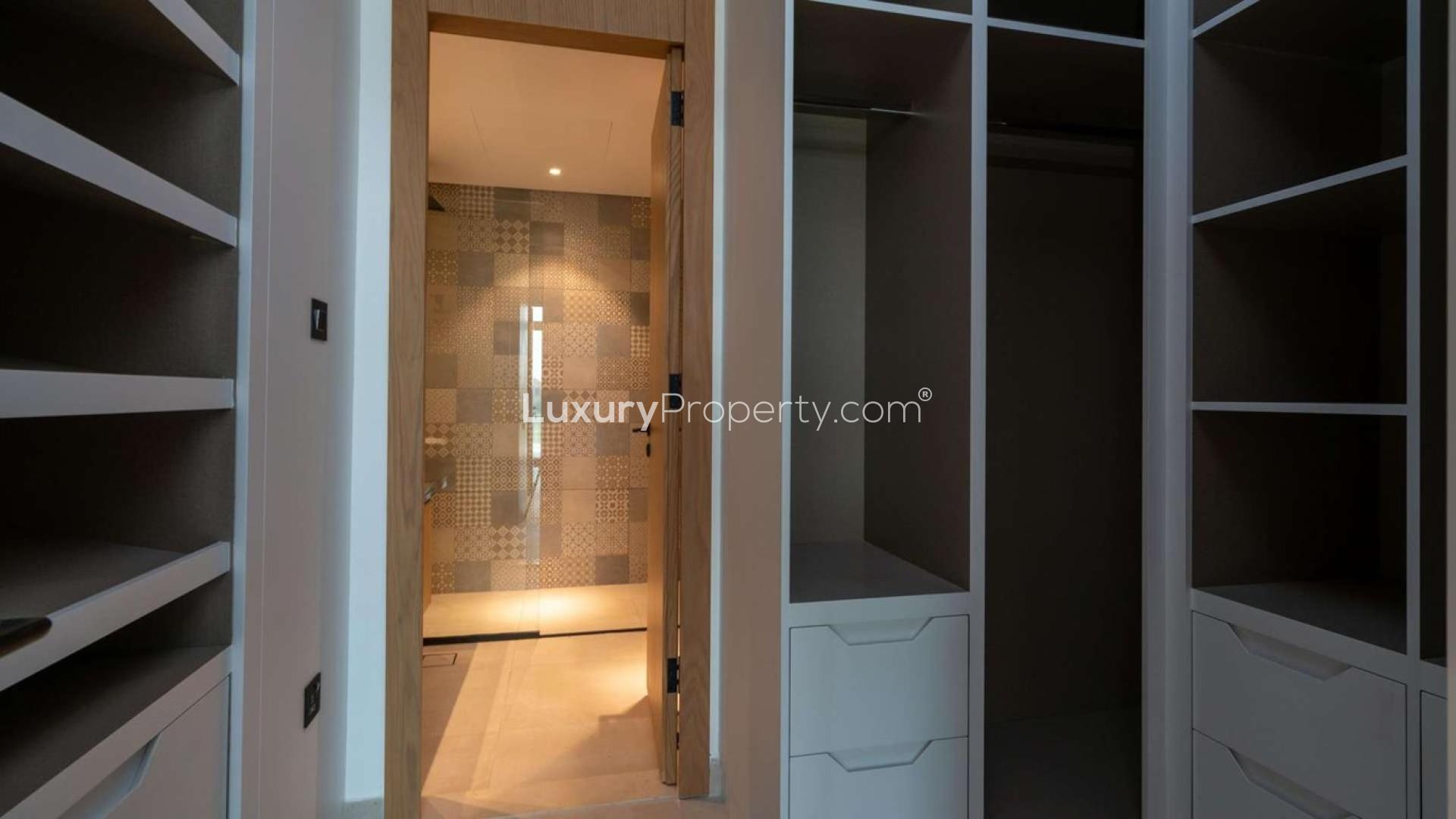 Modern walk-in closet with ample storage in Jumeirah Luxury townhouse, Jumeirah Golf Estates