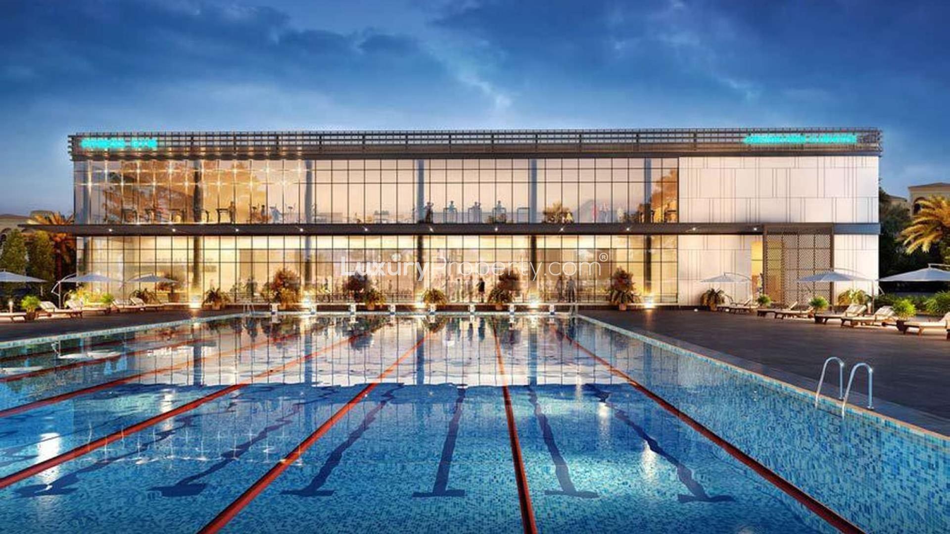 Modern community center exterior in Jumeirah Park Homes, Dubai, featuring glass facade and seating