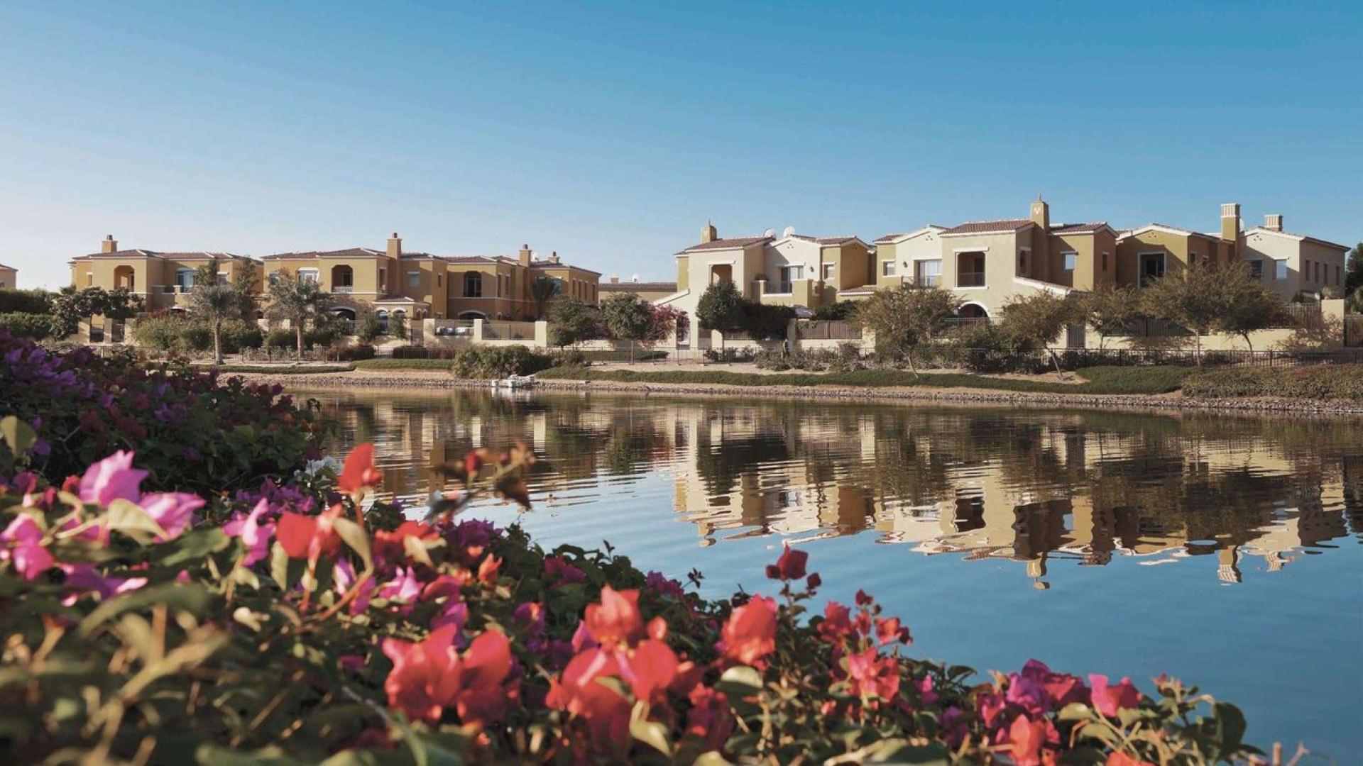Modern villa exterior at Camelia, Arabian Ranches II, Emaar, with carport and lush greenery