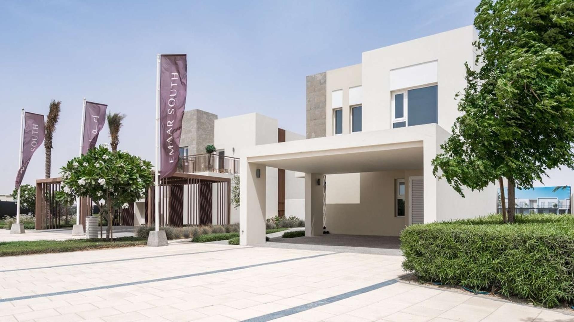 Modern bedroom with wooden headboard in Emaar South four-bedroom villa for sale