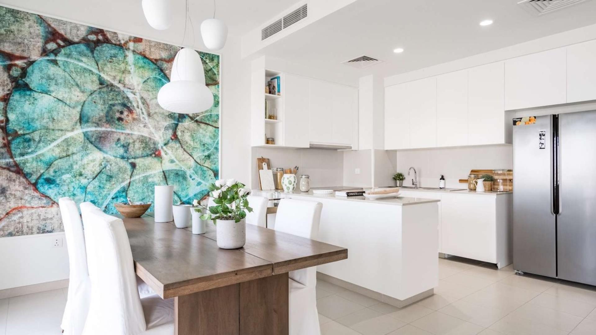 "Spacious entryway with staircase in four-bedroom villa, Emaar South, for sale.",Modern kitchen and dining area in Emaar South four-bedroom villa for sale