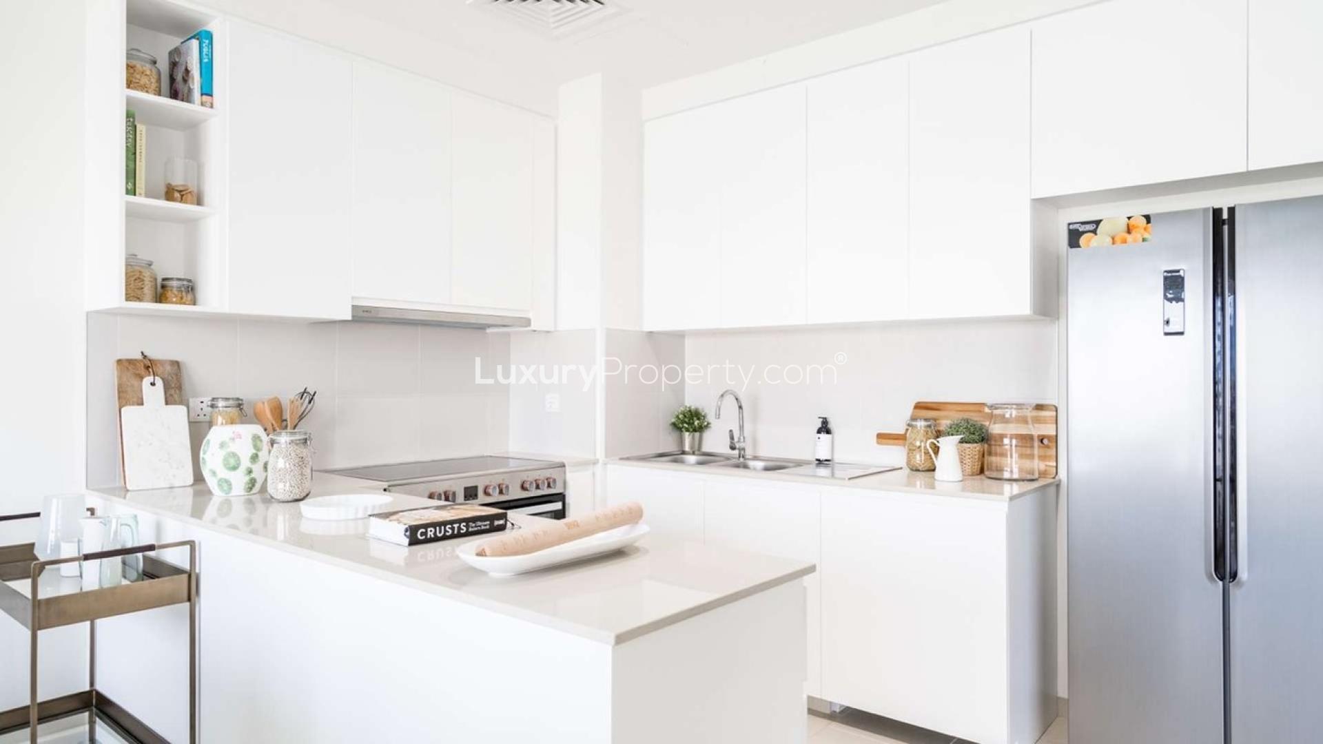 Modern kitchen and dining area in Emaar South three-bedroom villa for sale