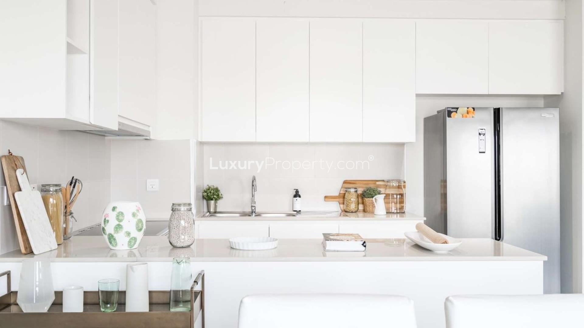 Modern dining area in Emaar South villa with abstract art and elegant decor