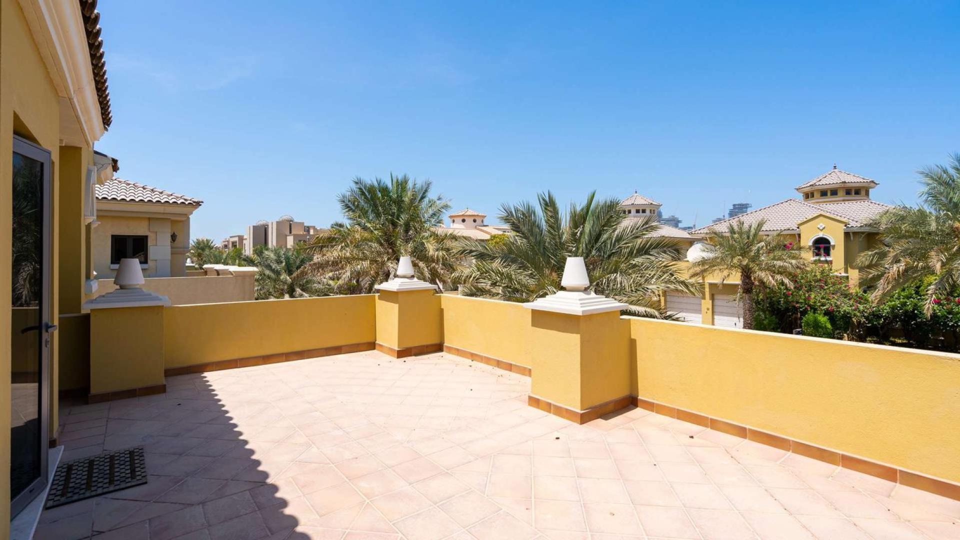 N/A,"Spacious terrace with palm views in Palm Jebel Ali villa, Garden Homes community.",Dining room in beachfront villa, Palm Jumeirah, with sea views and elegant decor