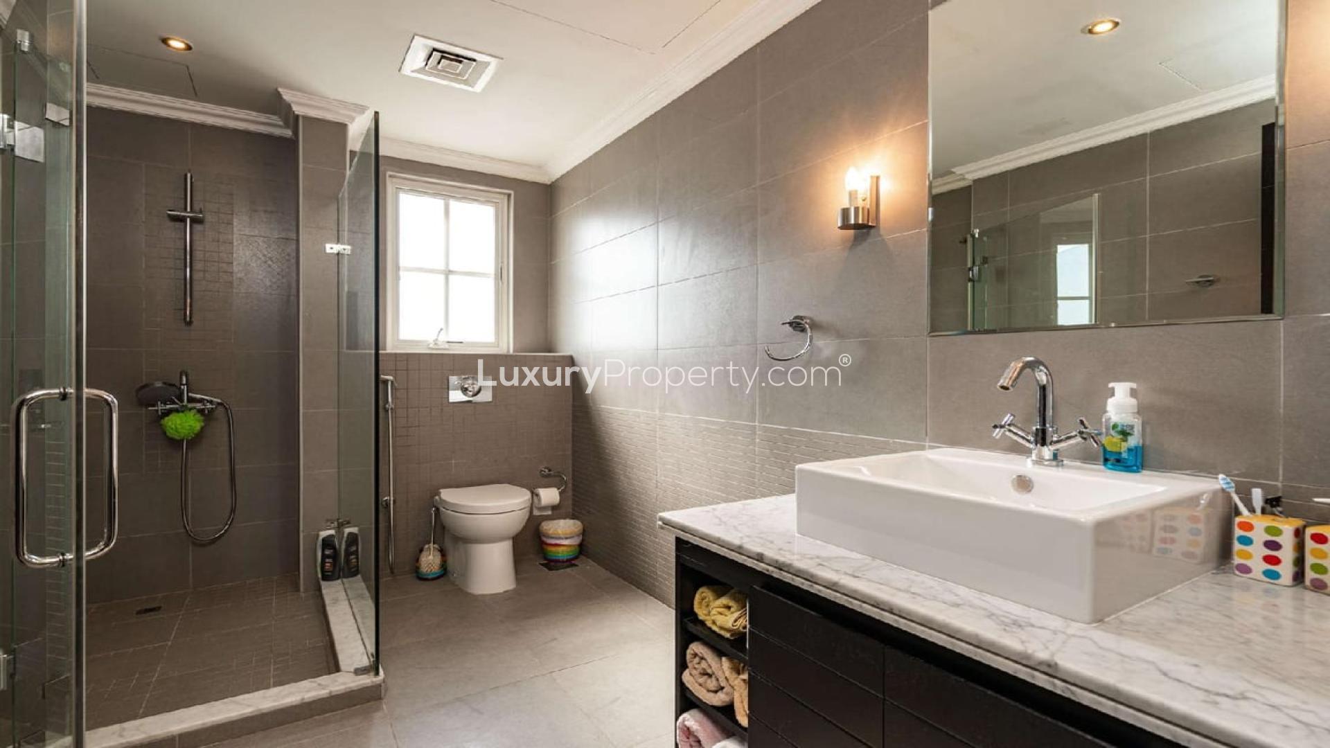 Modern bathroom in 4-bedroom Sawgrass Villa, Jumeirah Golf Estates, featuring glass shower and vanity