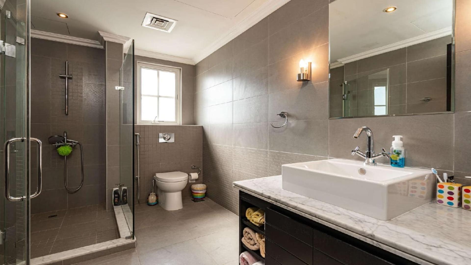 Modern bathroom in 4-bedroom Sawgrass Villa, Jumeirah Golf Estates, featuring glass shower and vanity