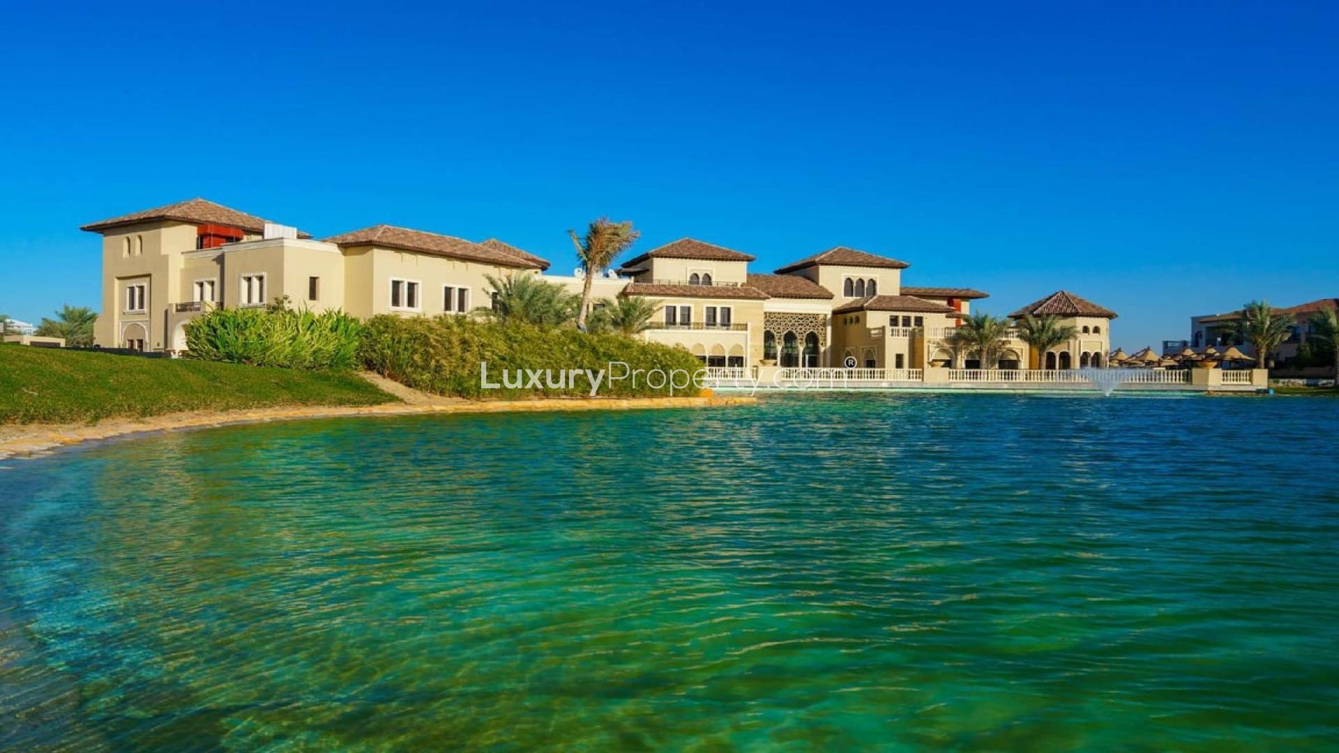 Spacious kitchen in four-bedroom villa, Orange Lake, Jumeirah Golf Estates, featuring modern wood cabinetry