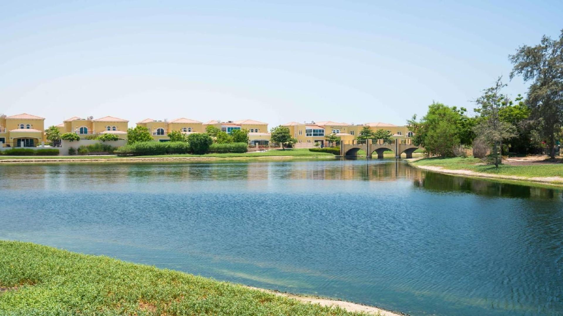 "Lake view of European Clusters villas in Jumeirah Islands, showcasing upgraded residential properties.",Luxurious living room in Jumeirah Islands villa with lake view and elegant decor