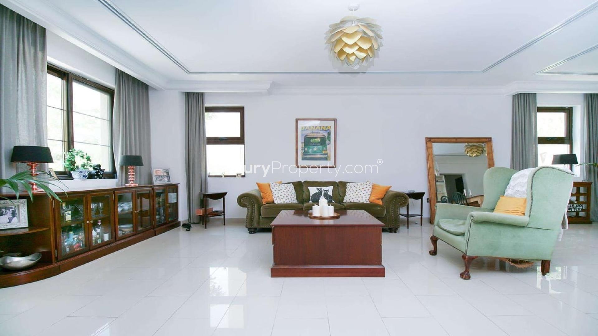 Modern villa pool area in Arabian Ranches 2, Dubai, with palm trees and seating