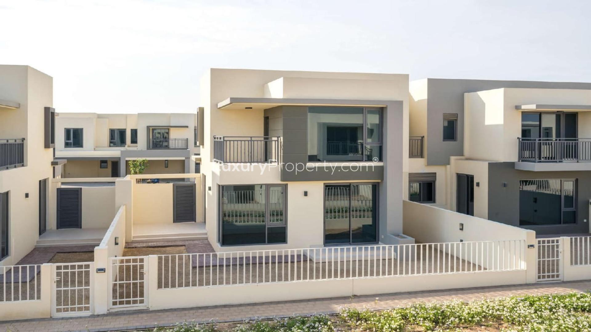 Empty room with large window overlooking modern villas in Dubai Hills Estate townhouse