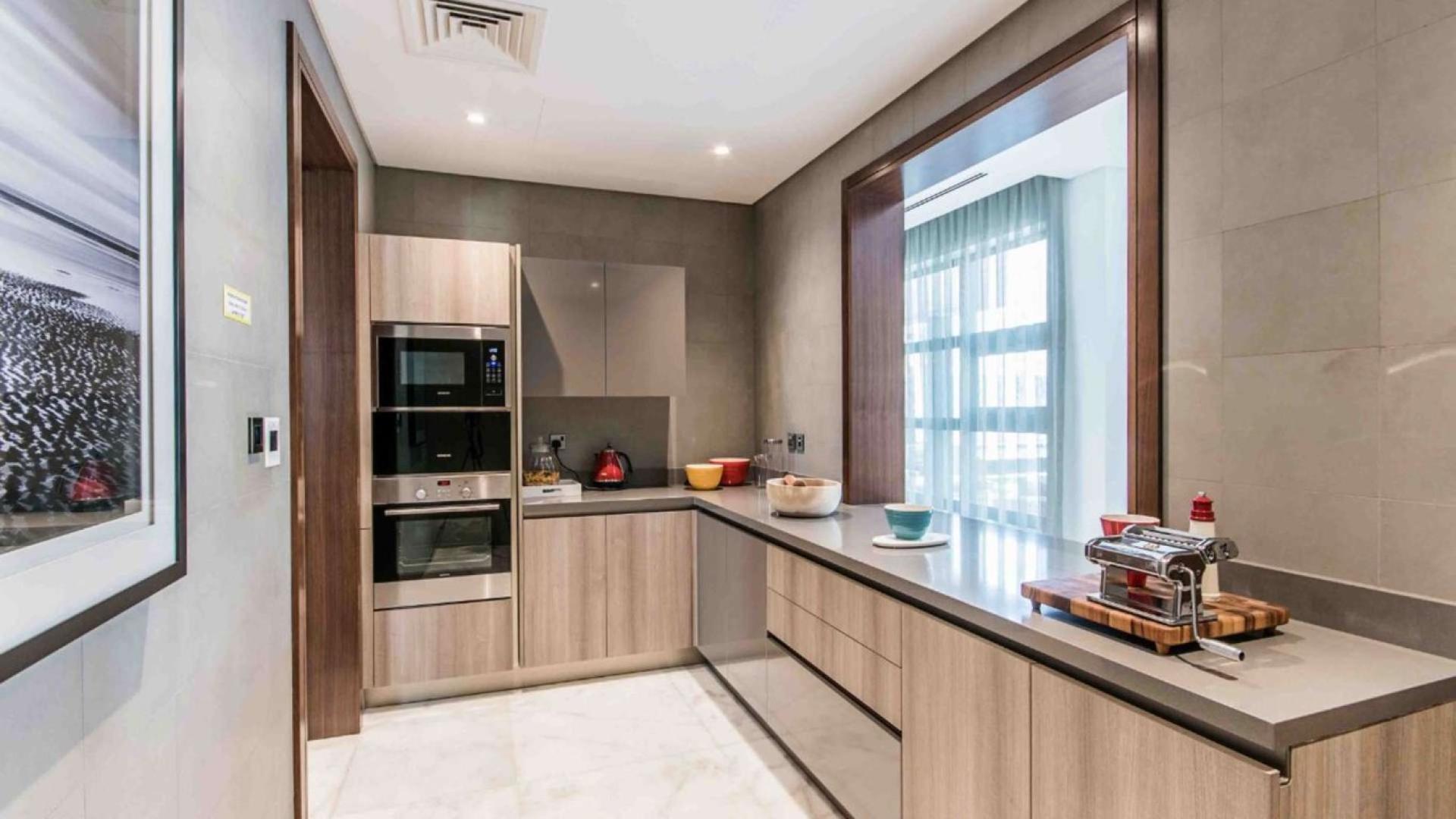 Luxurious living room in contemporary villa, Sobha Hartland, with large windows and modern decor