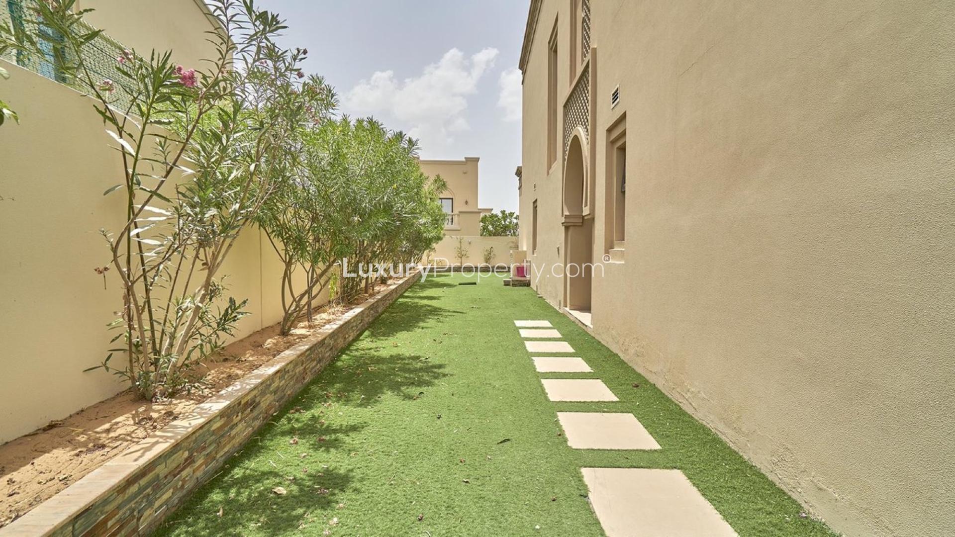 Spacious living room in Arabian Ranches 2 villa with garden view and elegant curtains