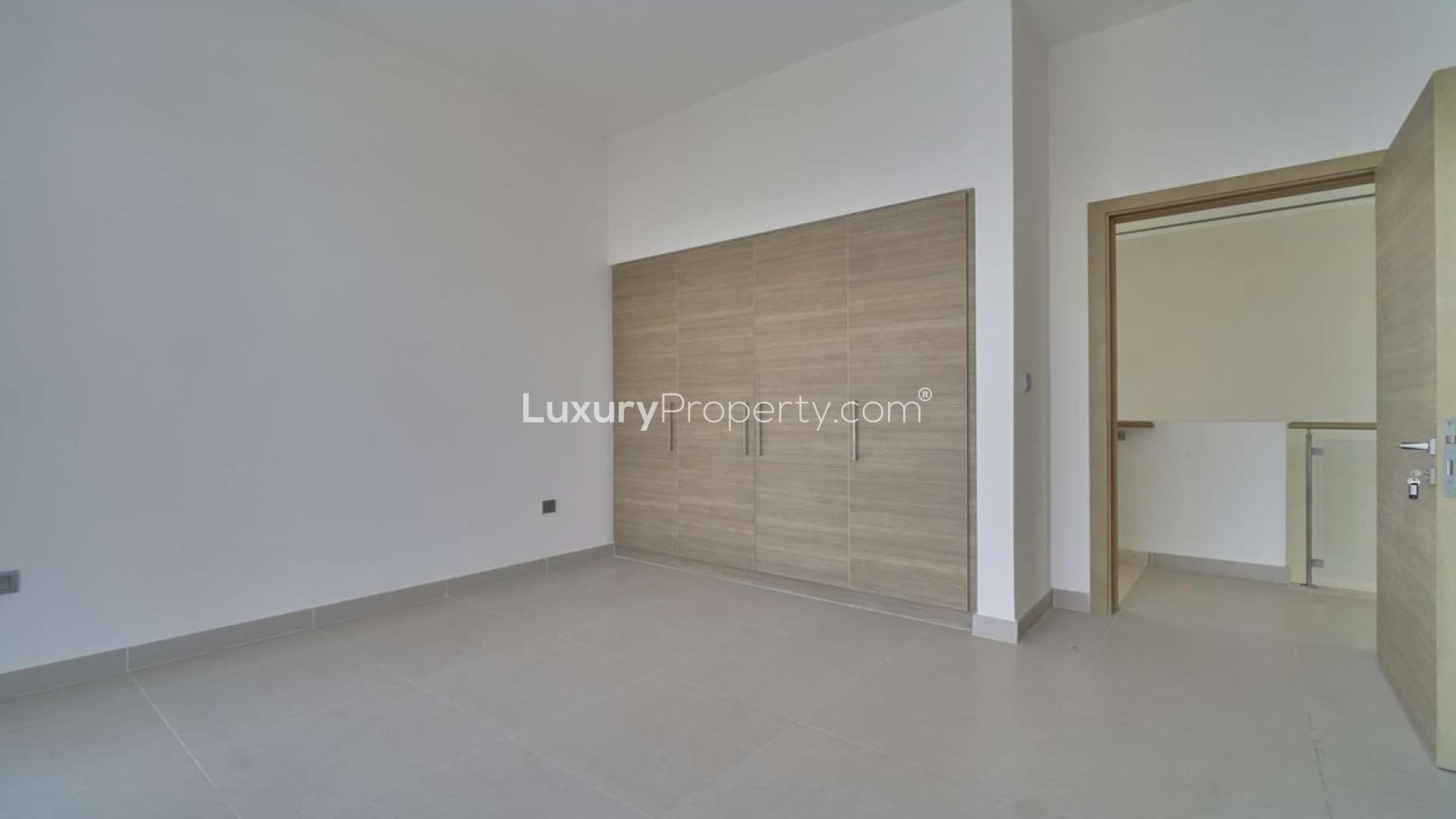 Modern 4-bedroom villa exterior in Sidra, Dubai Hills Estate with driveway and greenery