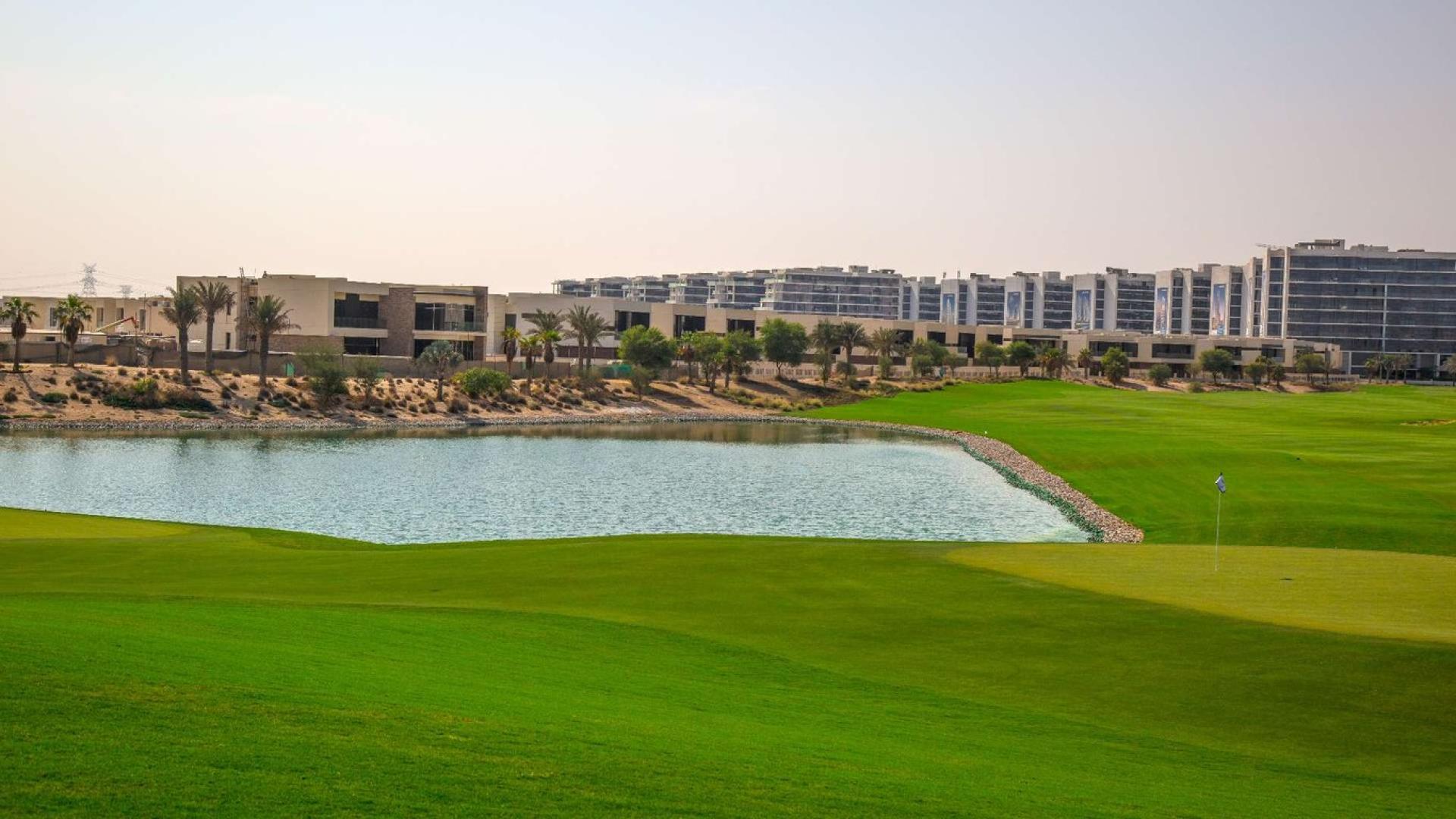 Modern living area in four-bedroom villa, The Legends, Damac Hills, with open kitchen and dining
