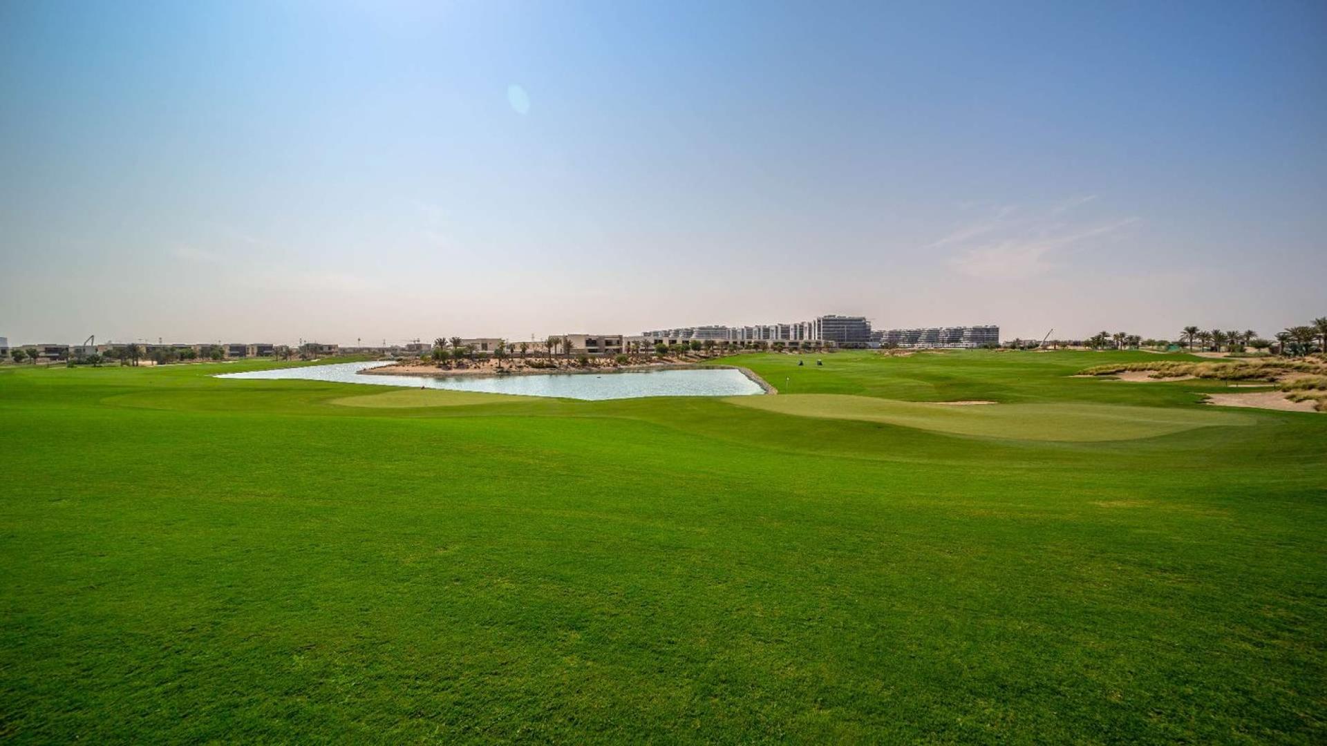 Luxurious bedroom in four-bedroom villa, The Legends, Damac Hills with balcony view