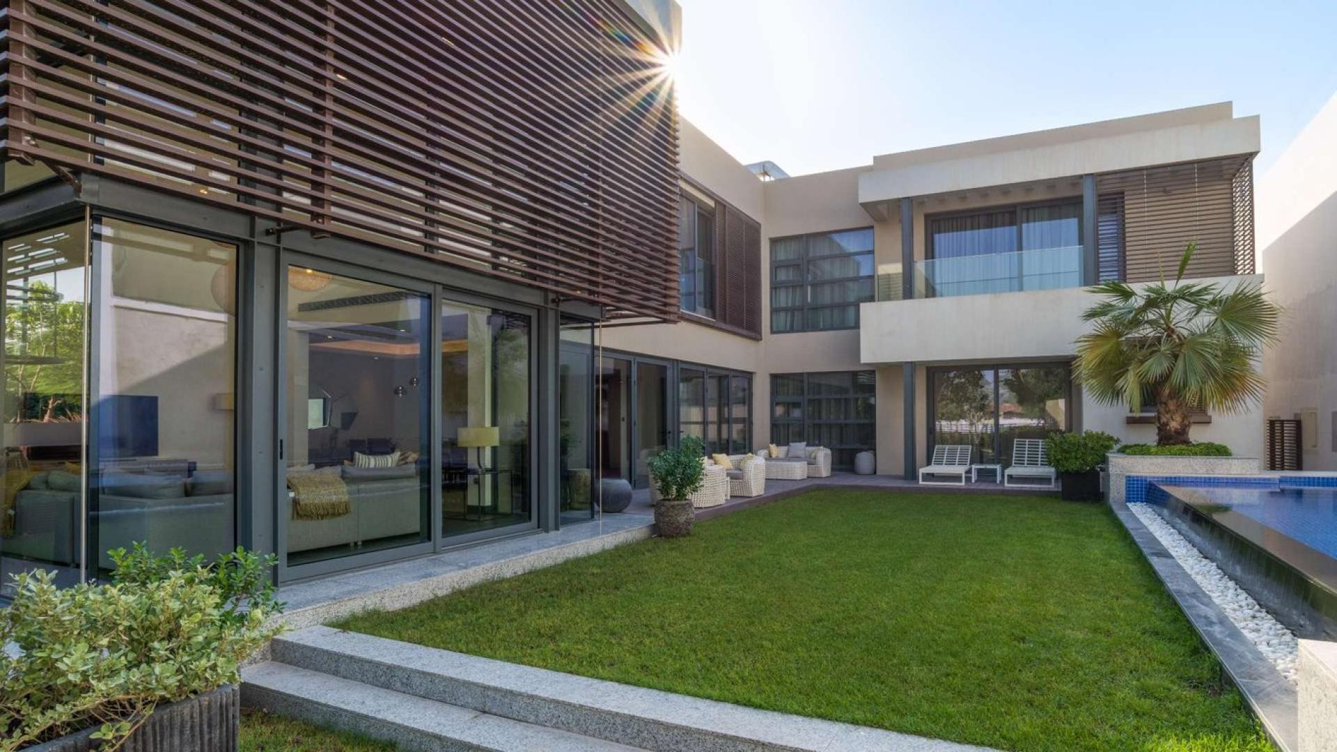 Luxurious living room in Sobha Hartland villa, featuring elegant decor and large windows