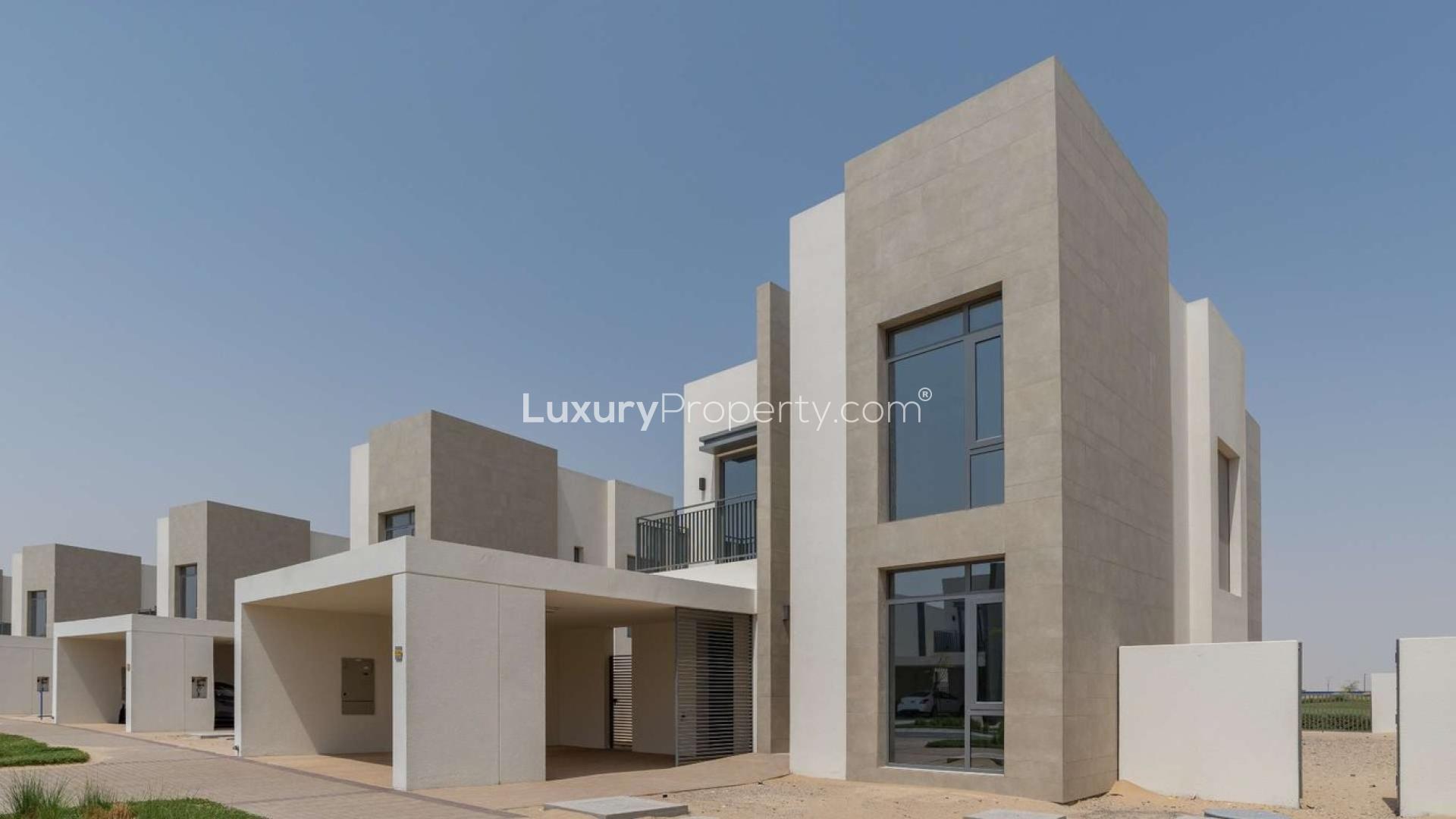 Modern four-bedroom villa exterior on golf course, available for sale, luxury property
