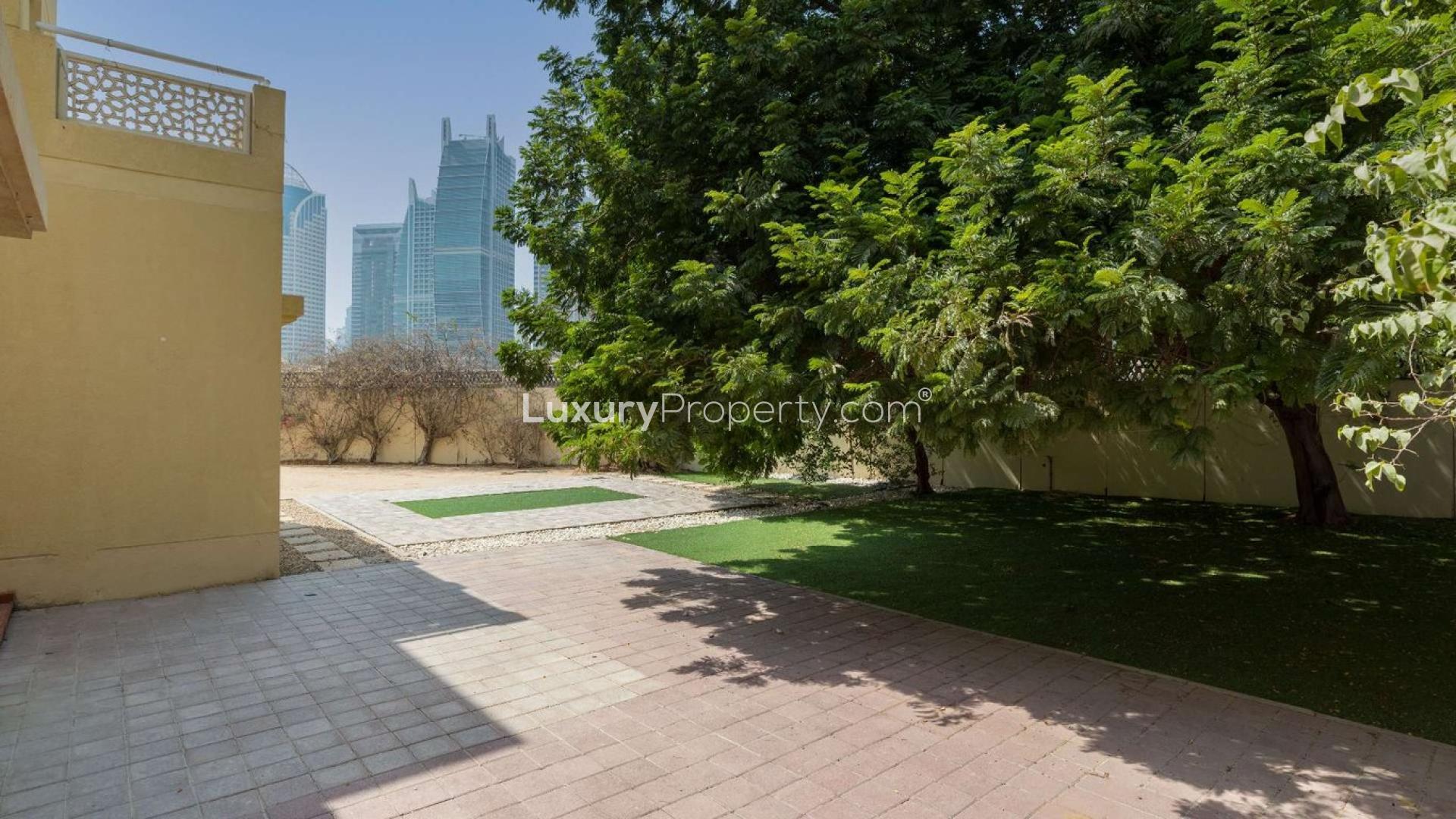 Interior view of villa with patio doors opening to lush garden, Meadows 2