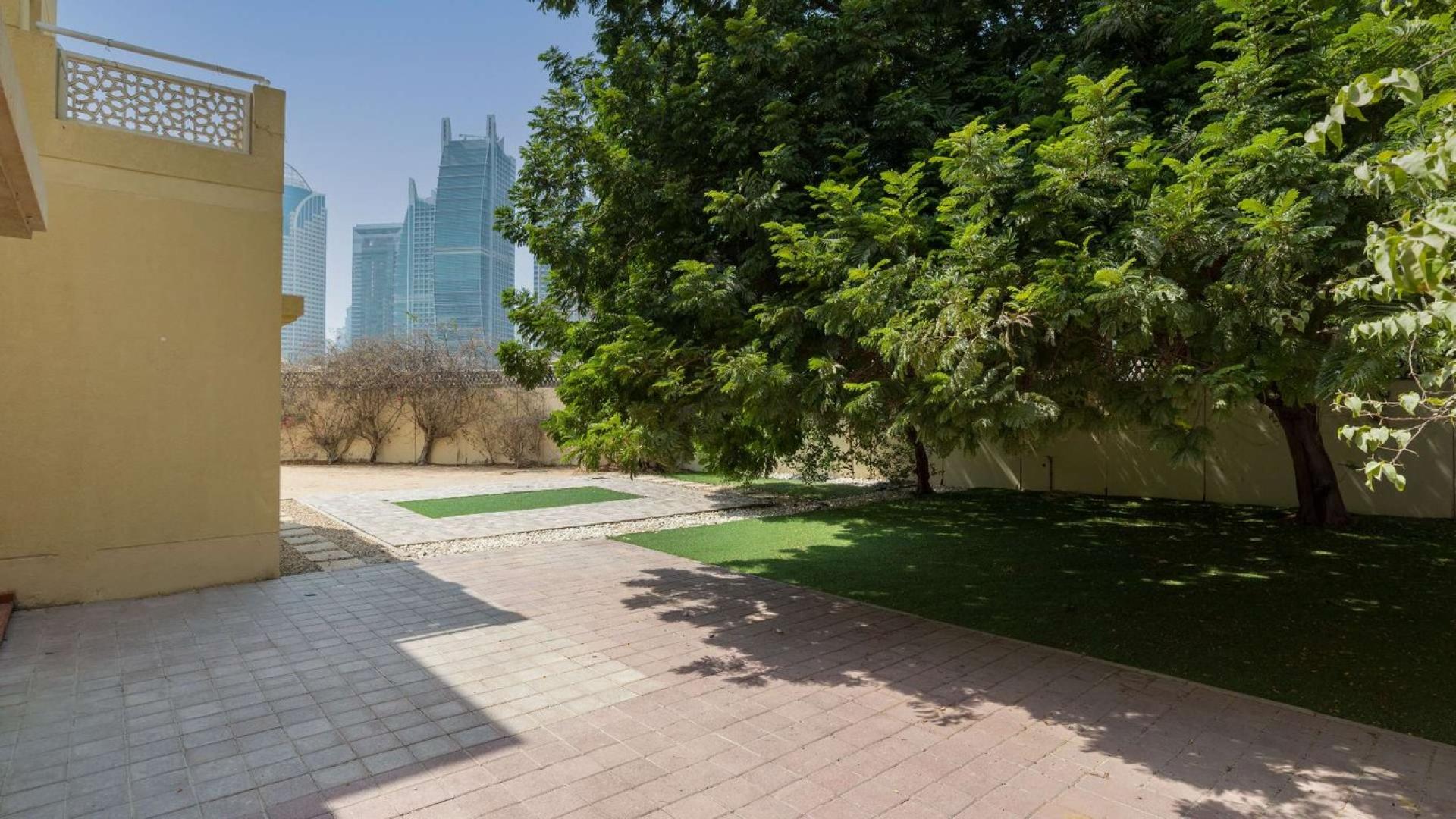 Interior view of villa with patio doors opening to lush garden, Meadows 2