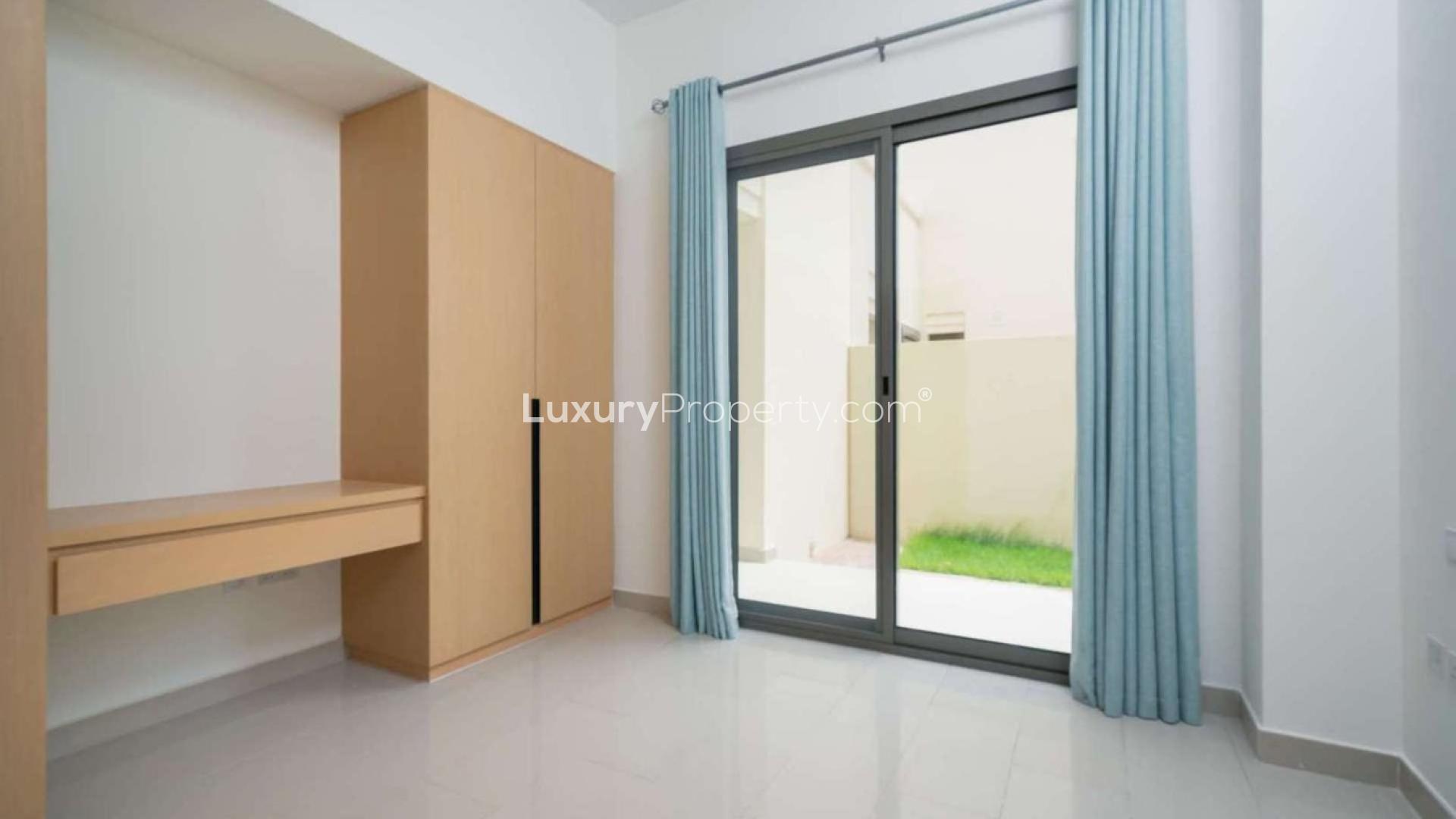 "Spacious 4-bedroom villa with garden in Arabian Ranches 2, Azalea, for sale.",Bright bedroom with built-in wardrobe and sliding glass doors in Azalea villa, Arabian Ranches 2