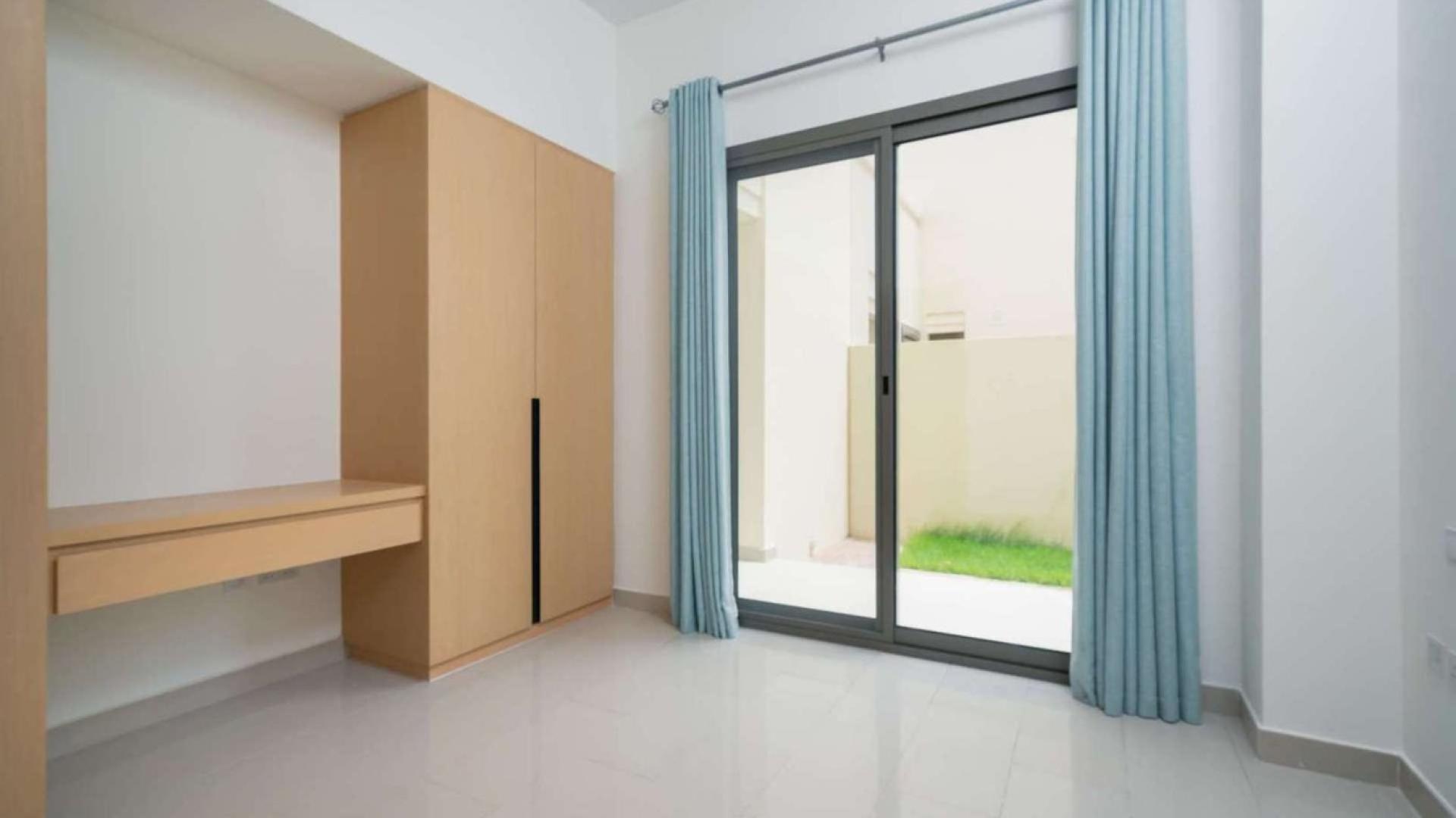 "Spacious 4-bedroom villa with garden in Arabian Ranches 2, Azalea, for sale.",Bright bedroom with built-in wardrobe and sliding glass doors in Azalea villa, Arabian Ranches 2