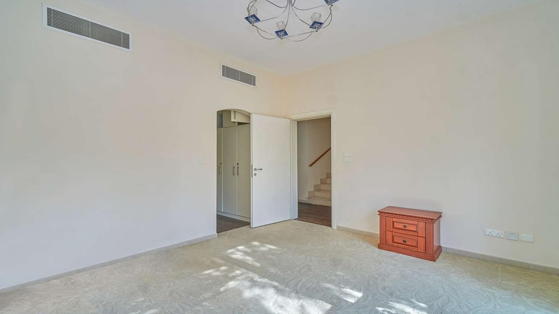 Lush garden with palm trees in Meadows 2 villa, perfect for family relaxation and play