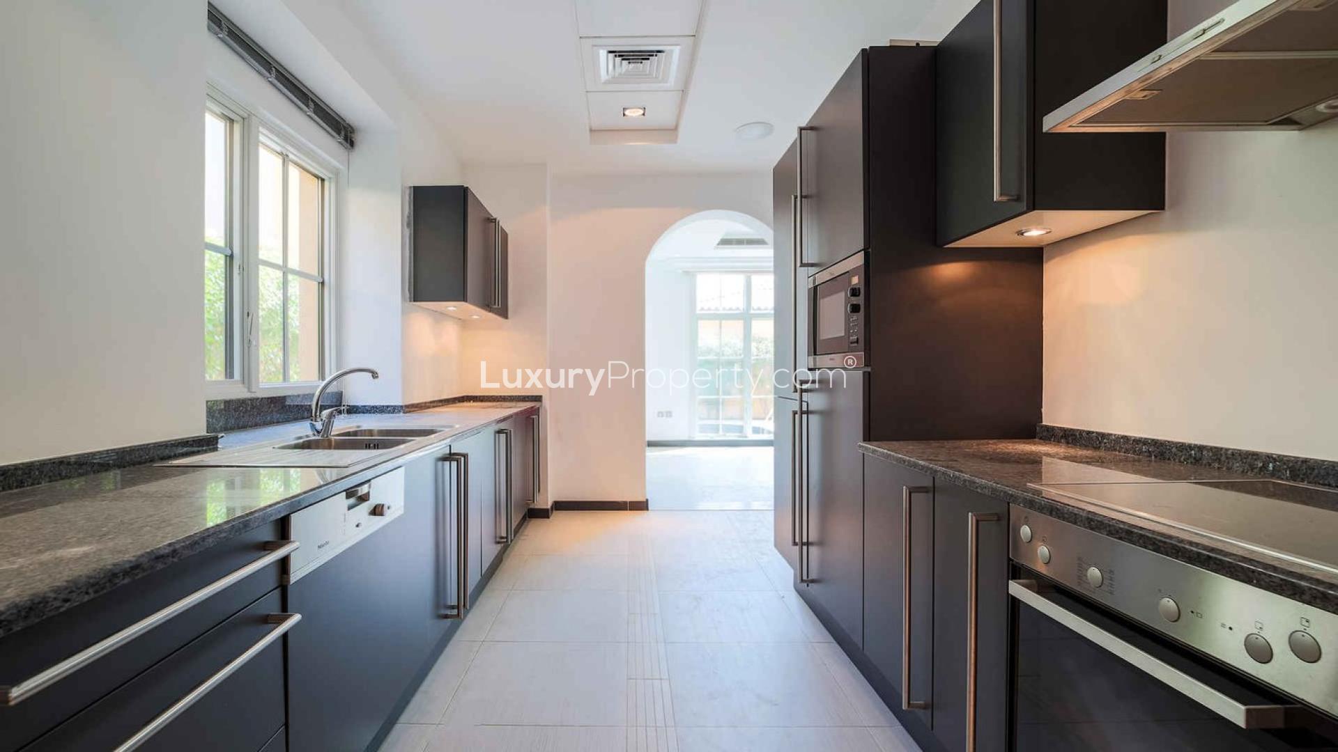 Exterior view of 4-bed villa in Whispering Pines, Jumeirah Golf Estates, with spacious driveway