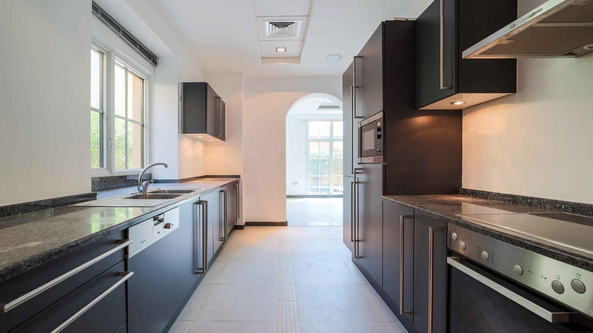 Exterior view of 4-bed villa in Whispering Pines, Jumeirah Golf Estates, with spacious driveway