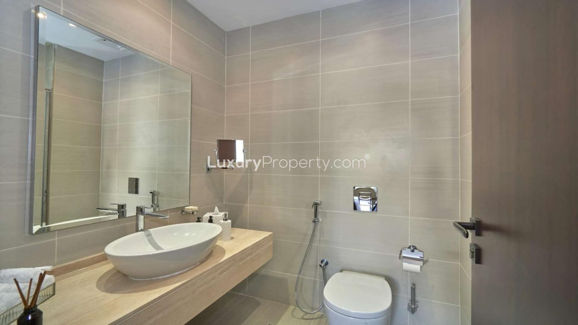 Luxurious living room in upgraded Damac Hills villa, featuring elegant modern decor and art