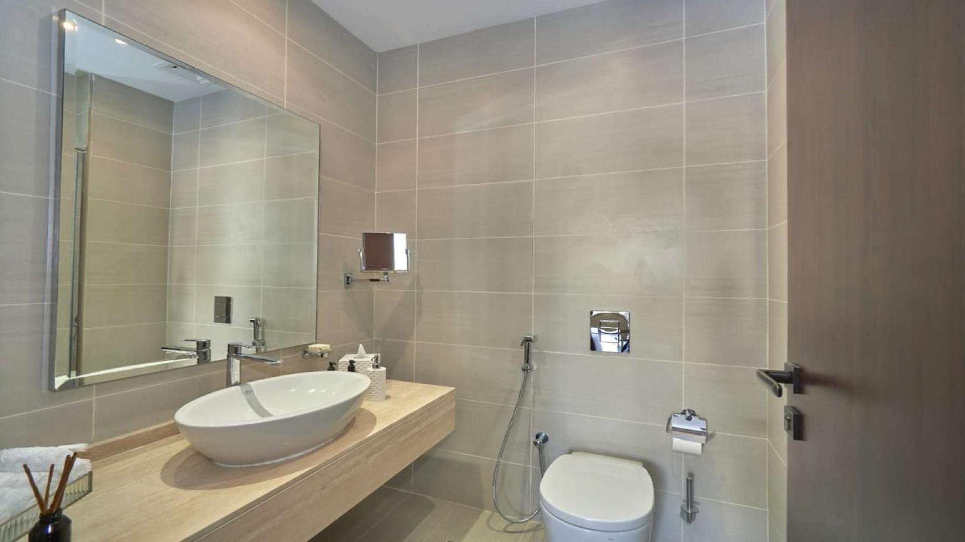 Luxurious living room in upgraded Damac Hills villa, featuring elegant modern decor and art