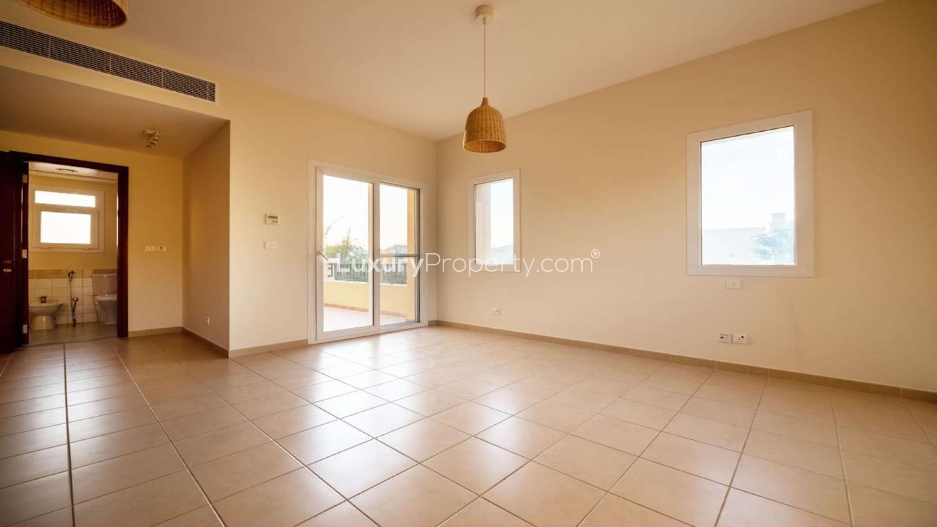 Empty living room with tiled floors in Palmera villa, Arabian Ranches, Dubai, for sale