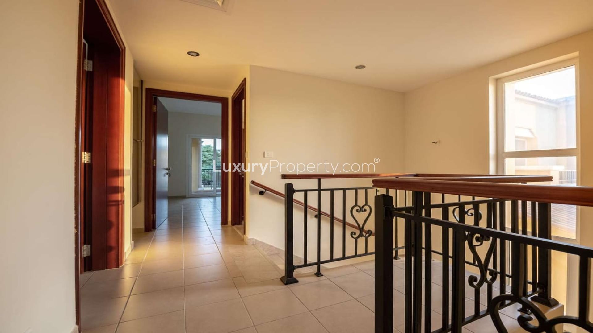 Four-bedroom villa courtyard with artificial grass in Palmera, Arabian Ranches, for sale