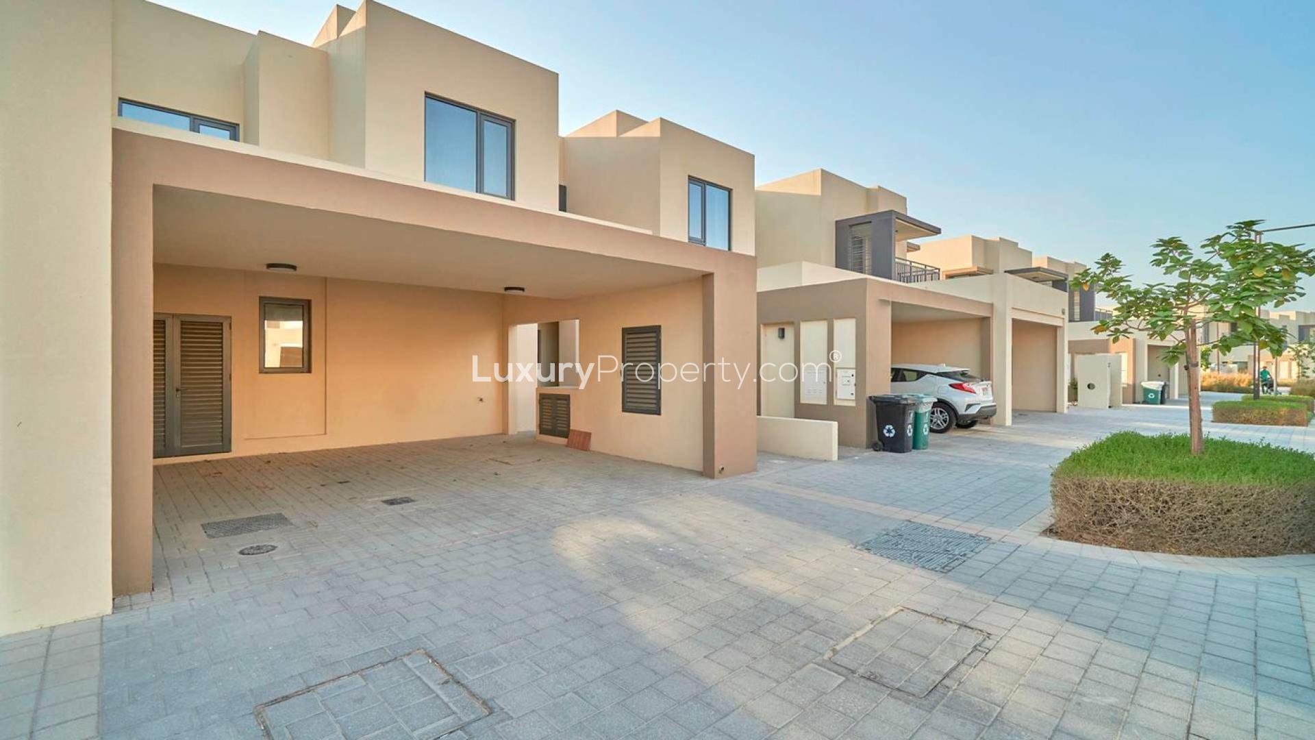 Front view of a modern villa in Maple, Dubai Hills Estate, with parking area
