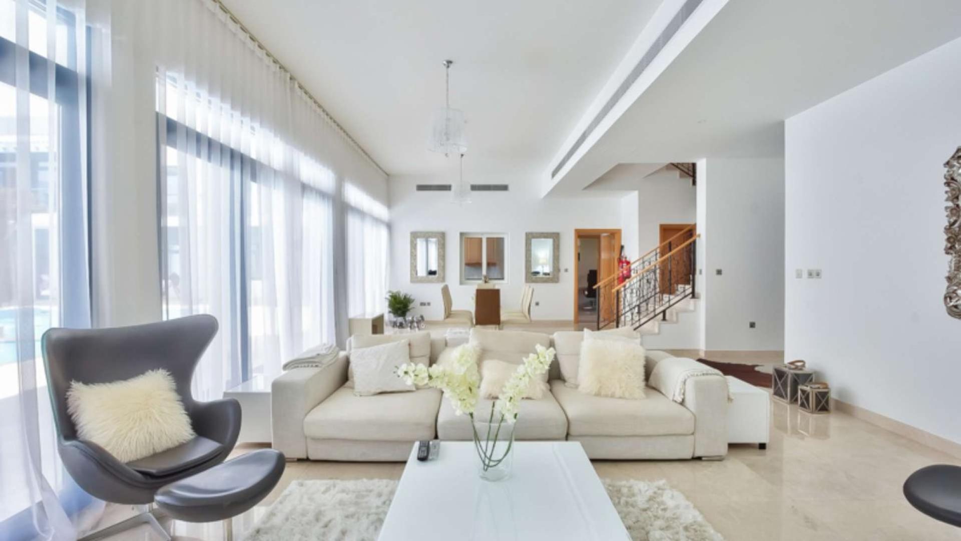 Modern living room in beachfront villa, Palm Jumeirah, with pool view and elegant decor