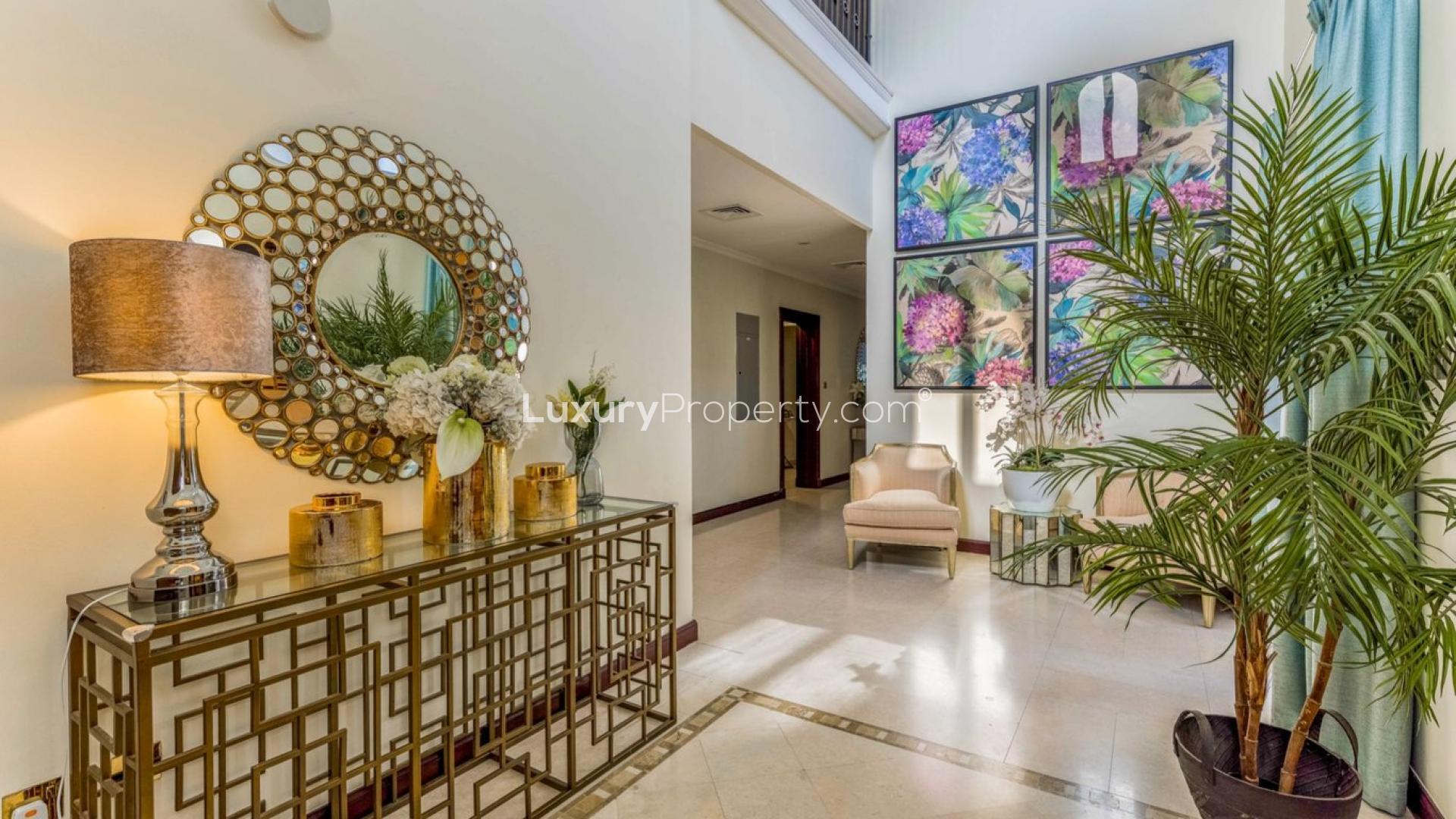 Luxurious living room in upgraded 4-bedroom villa, Palm Jumeirah, with elegant decor and chandelier
