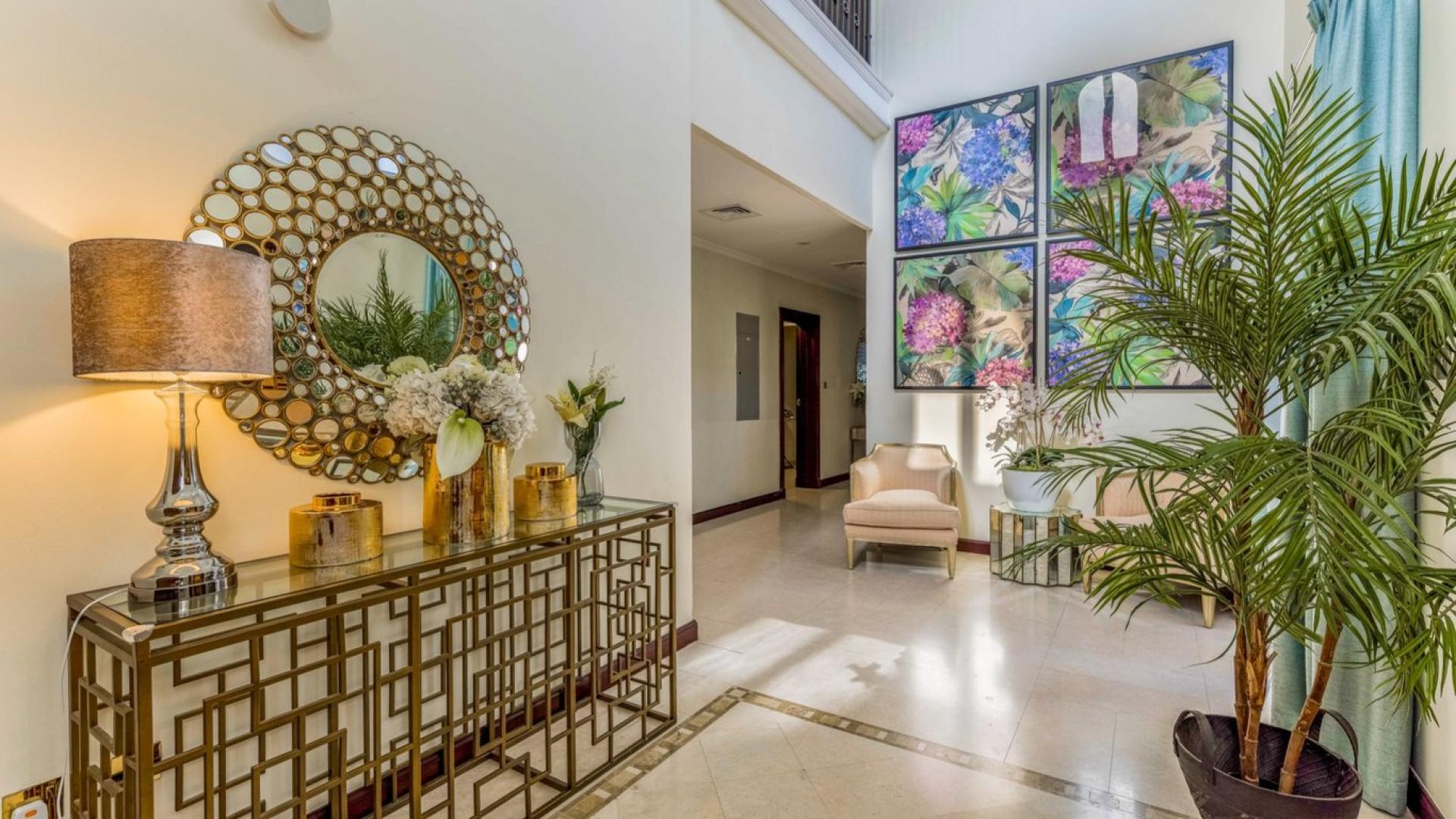 Luxurious living room in upgraded 4-bedroom villa, Palm Jumeirah, with elegant decor and chandelier