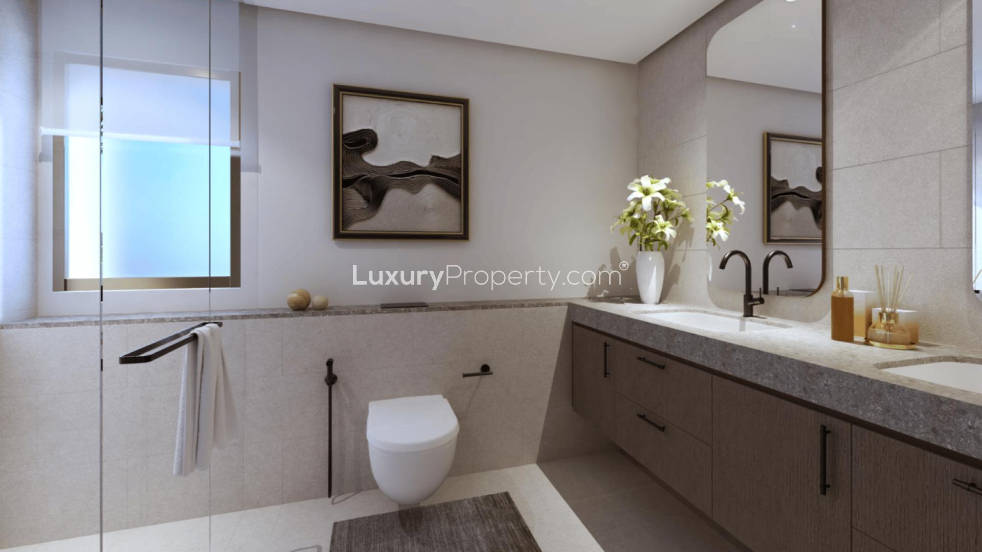 Modern townhouse exterior in Villanova, Dubai Land, featuring carport and landscaped surroundings