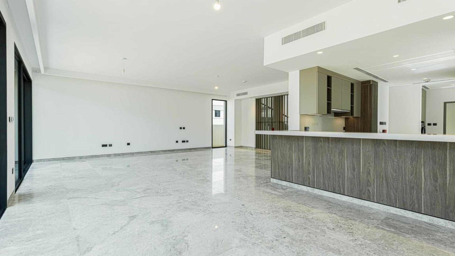 "Spacious living area with large windows in Harmony Phase 2 villa, Tilal Al Ghaf.",Bright, spacious kitchen and living area in Harmony Phase 2 corner villa, Tilal Al Ghaf