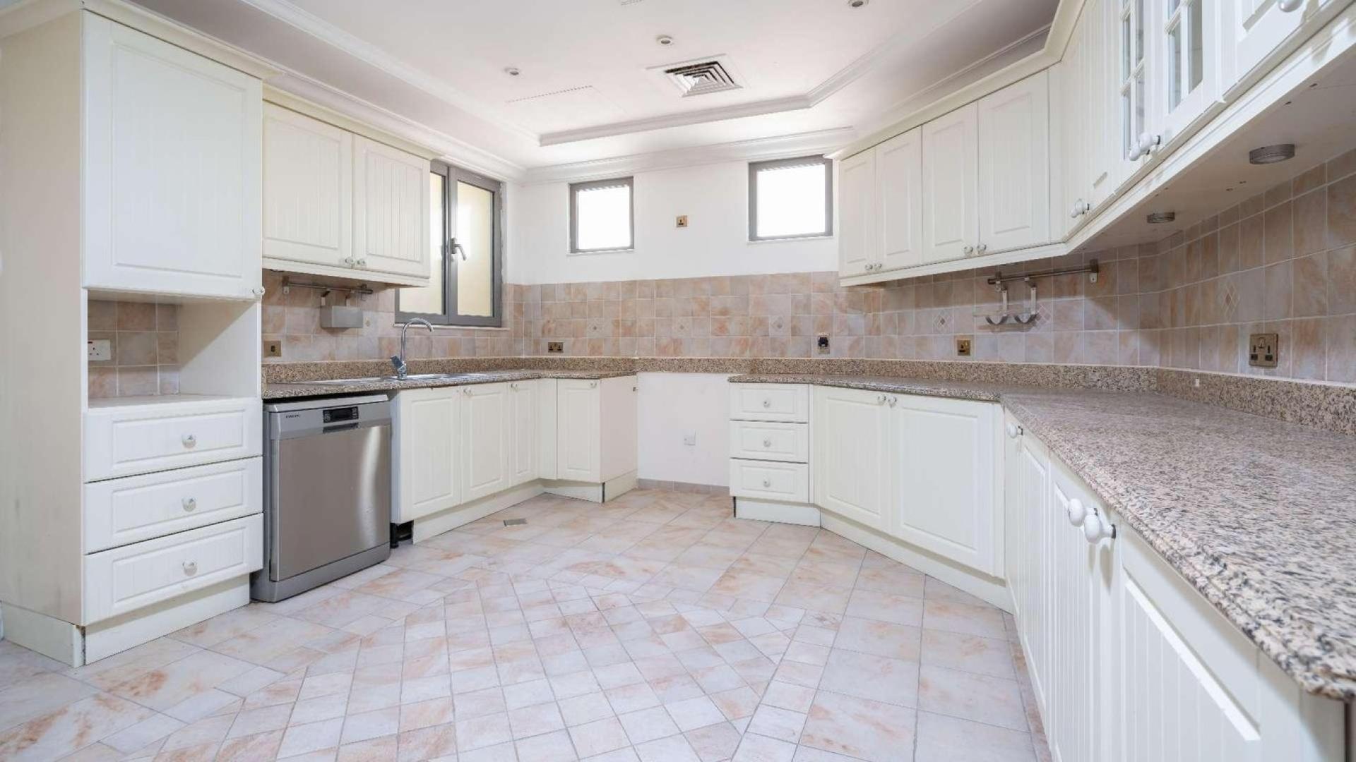 Empty room with large windows in renovated Palm Jumeirah villa for sale