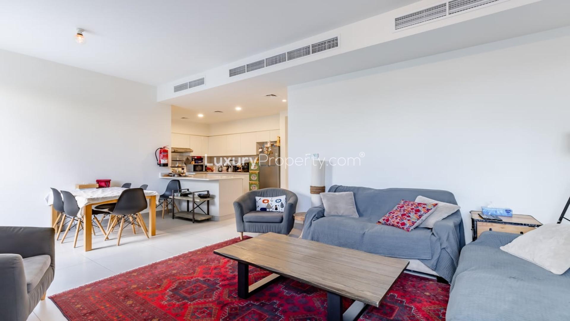 Lush garden view of Maple 2 townhouse in Dubai Hills Estate with outdoor seating