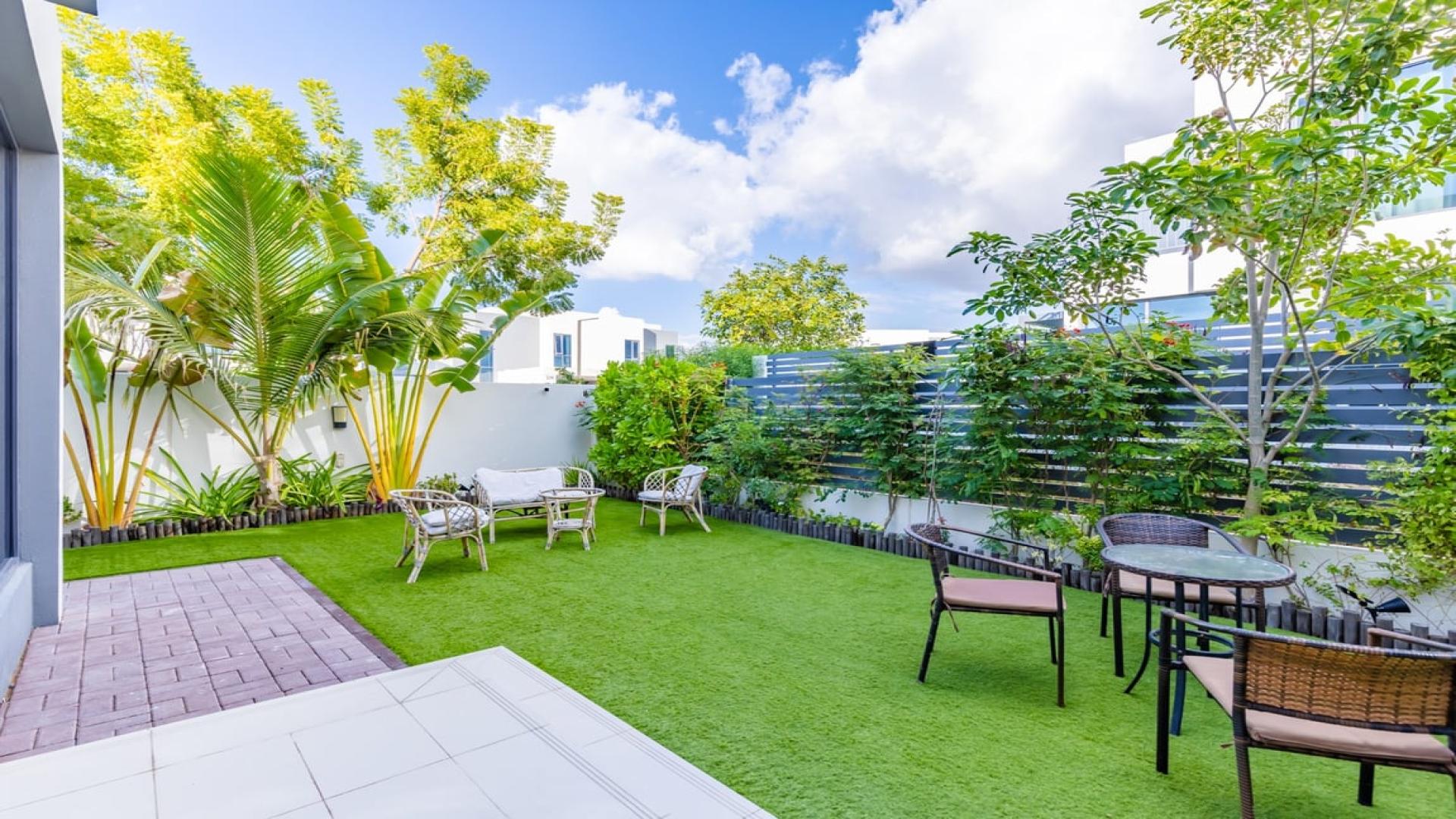 Living room in 4-bed townhouse, Maple 2, Dubai Hills Estate, with modern decor and furniture