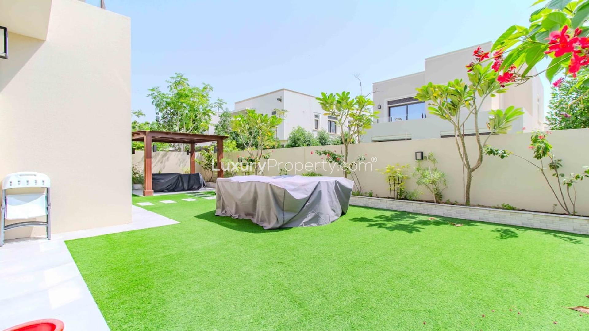 "Spacious living room in upgraded villa, Arabian Ranches 2, Azalea, with modern decor and natural light.",Spacious backyard with gazebo in Azalea villa, Arabian Ranches 2, lush green lawn