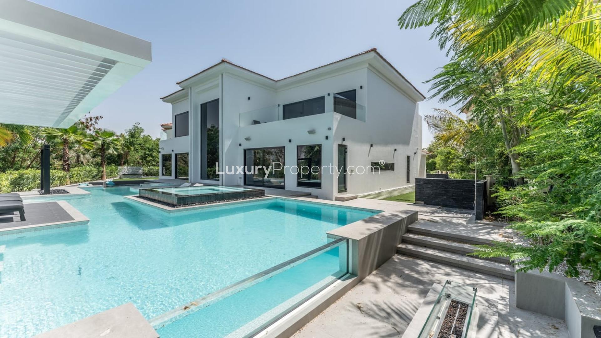 Modern villa interior with large window view of pool, Jumeirah Islands European Clusters