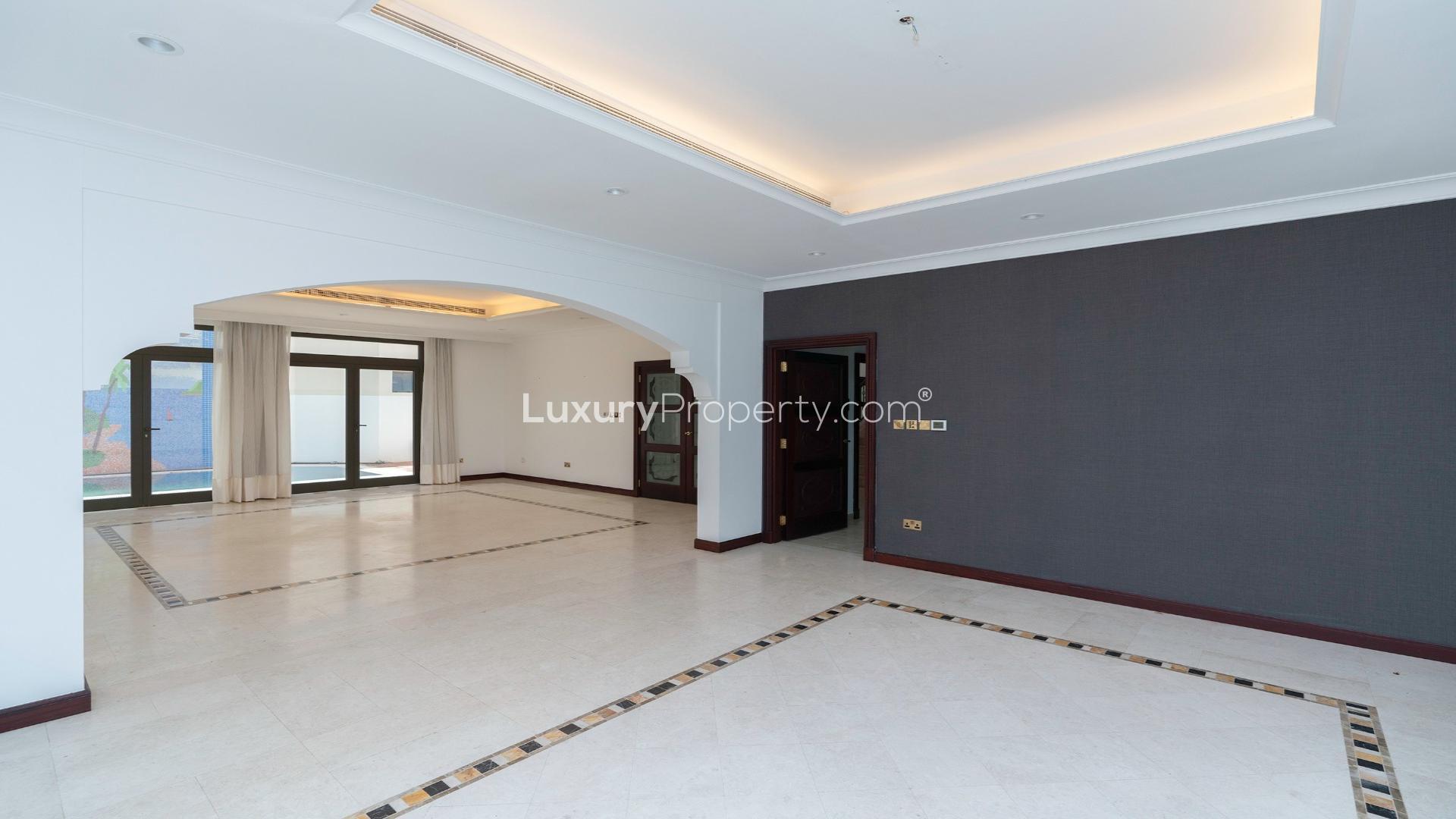 Spacious living room in Palm Jumeirah villa with large windows and elegant flooring