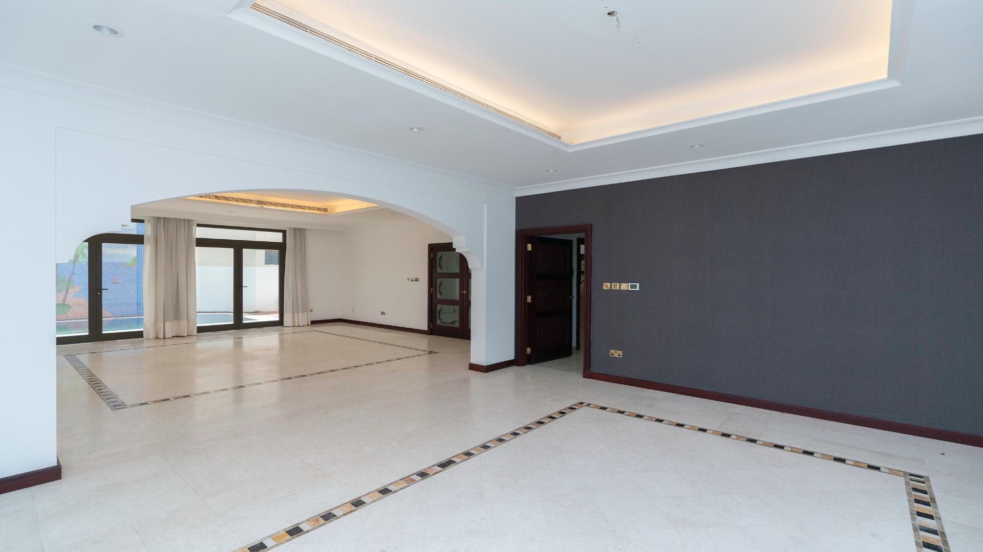 Spacious living room in Palm Jumeirah villa with large windows and elegant flooring